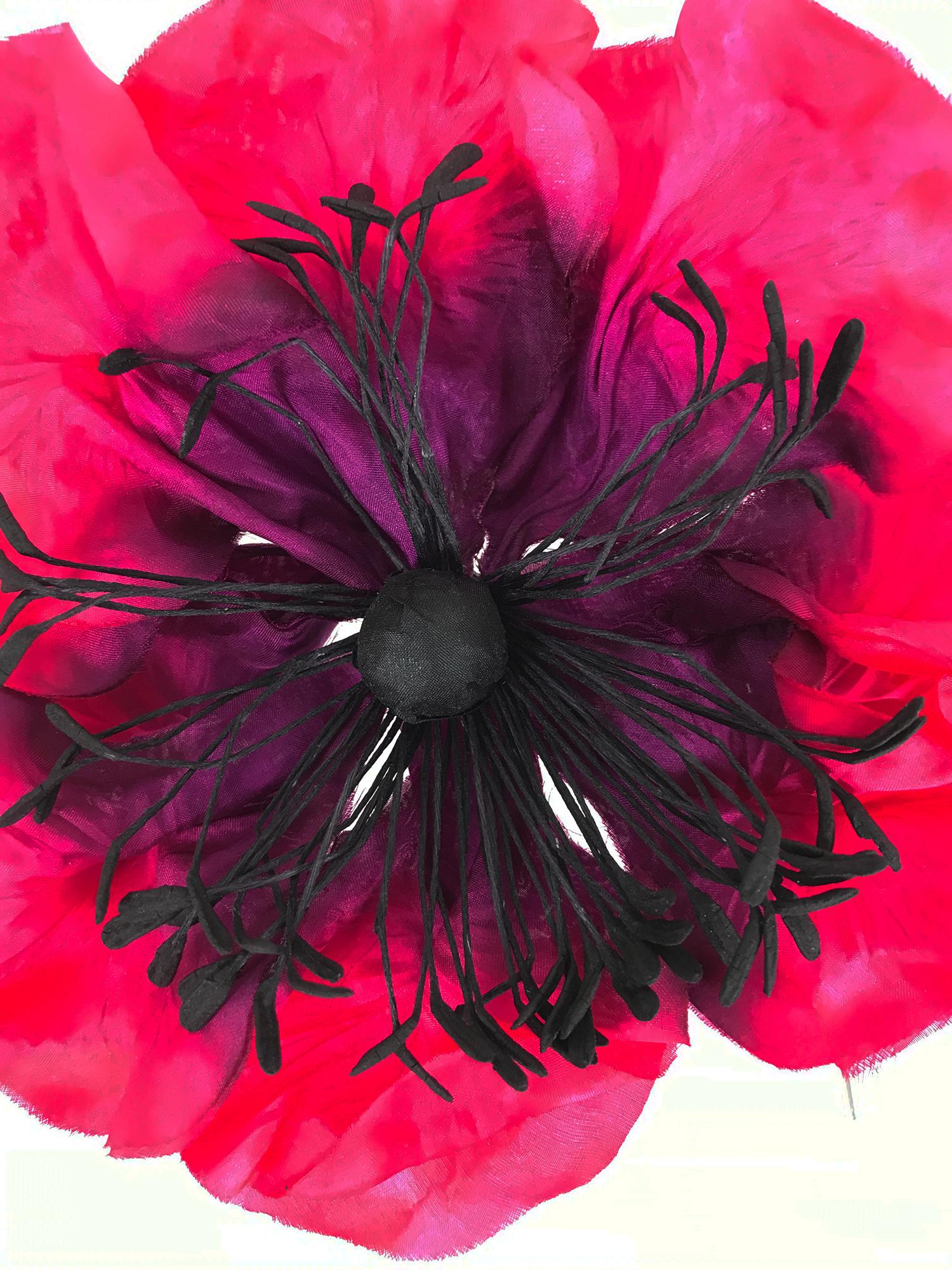 Vintage large hot pink and purple silk fantasy Poppy corsage from the 1990s. The perfect addition to any outfit. Large silk petals are hot pink with purple centers, the stamens and center are black. The back has a silver pin that closes to attach to