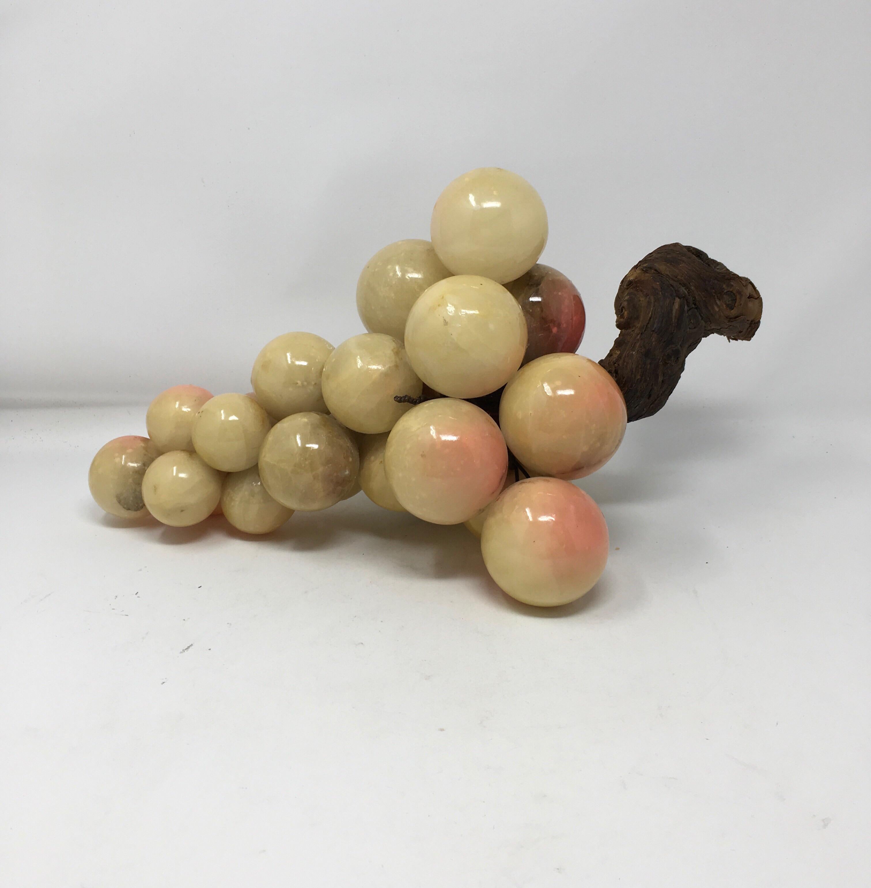 This cluster of colorful vintage Italian Alabaster grapes are handcrafted with a real wood grape vine branch handle. Each grape is hand painted to create a realistic appearance. These grapes would make a great addition to any centerpiece or would
