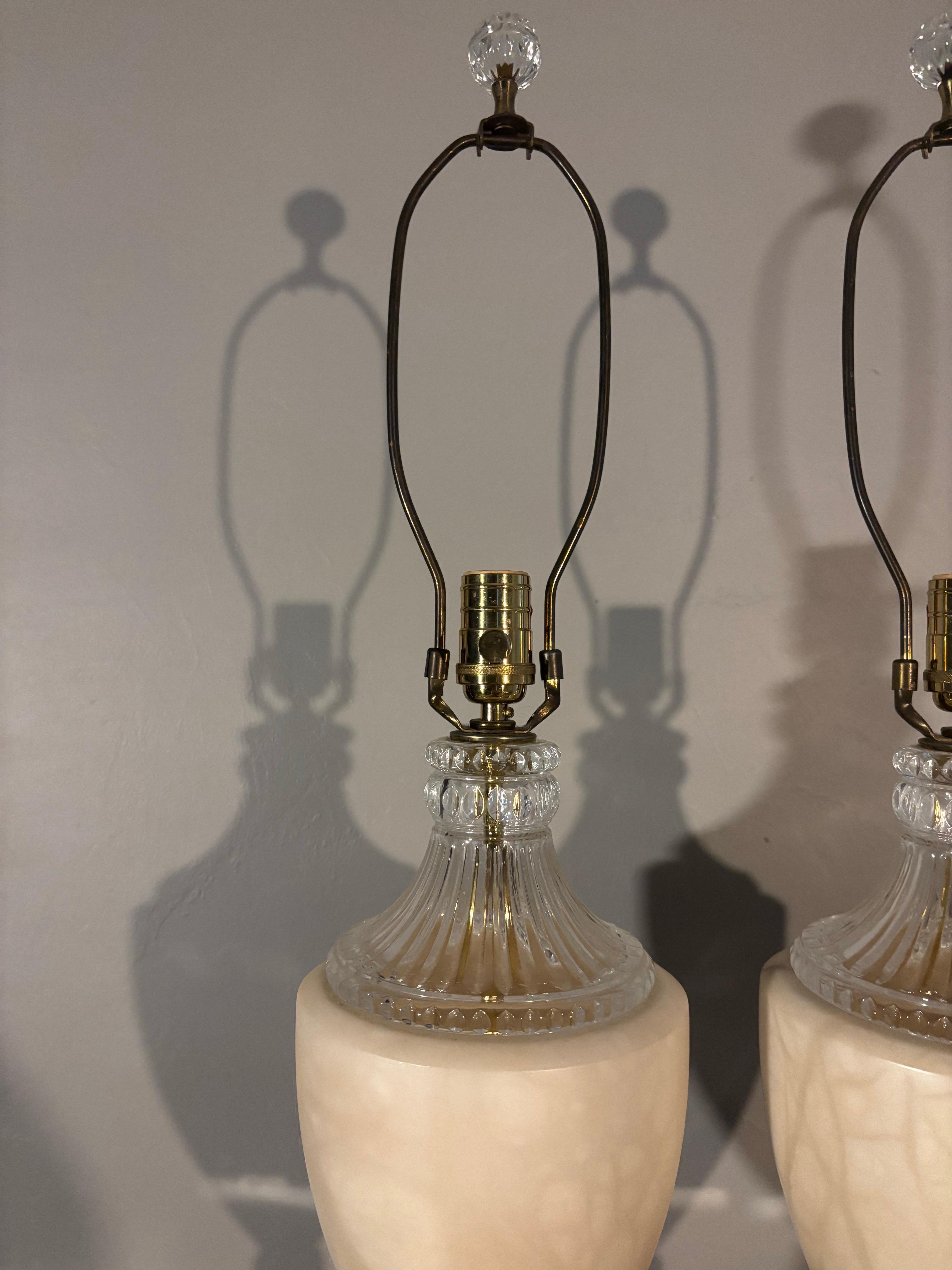 Beautiful pair of vintage Italian marble and crystal glass lamps. A classic elegantly carved shape with a square base and an urn style body. Crystal is carved and creates a beautiful complimentary contrast to the smooth marble. The soft neutral