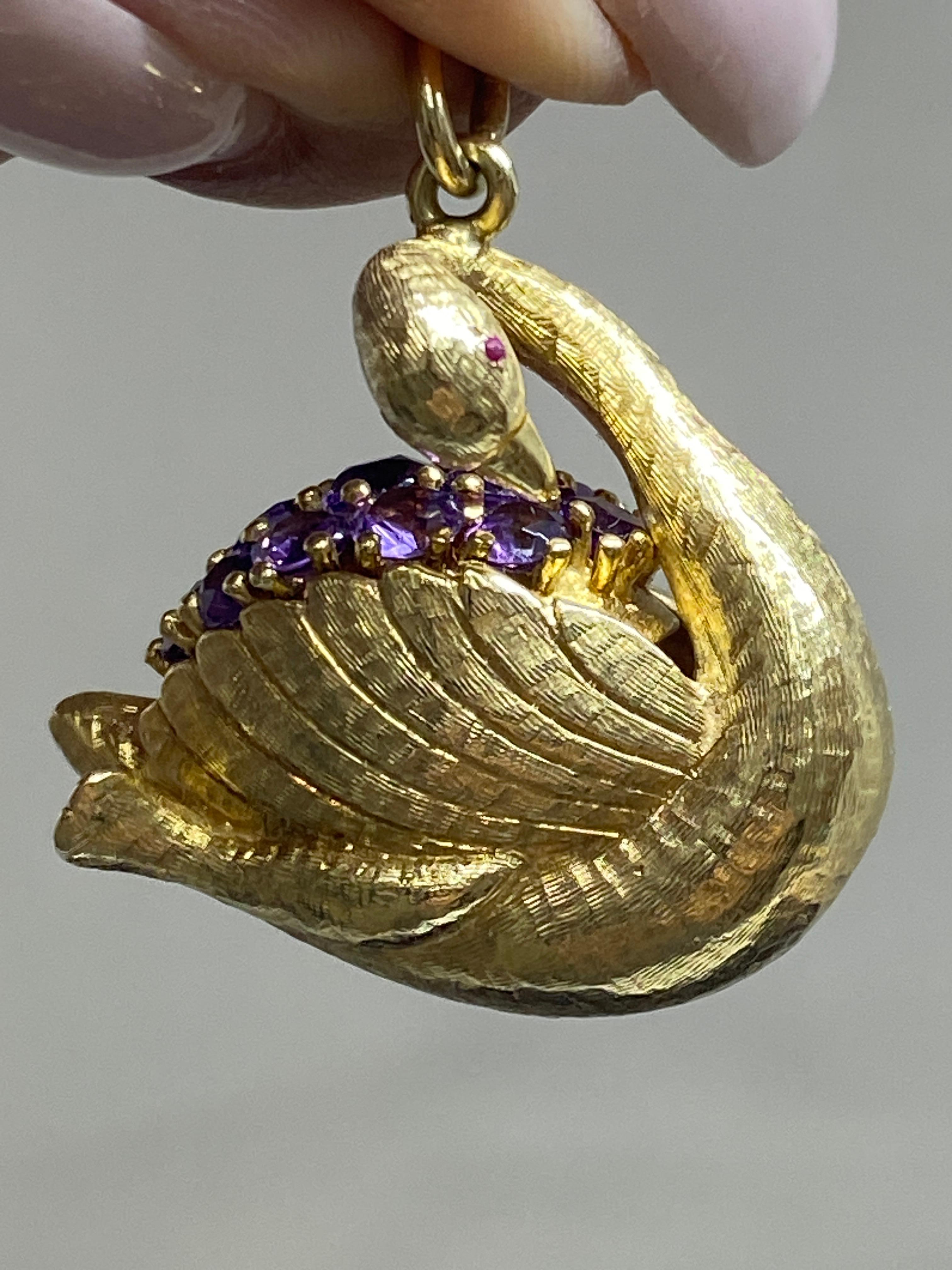 Calling all vintage charm collectors.... this beauty is for you!

Here we a very finely made three dimensional swan charm crafted in heavy 14k yellow gold in a stunning textural florentine finish. 
This is a very elegant swan featuring a long turned
