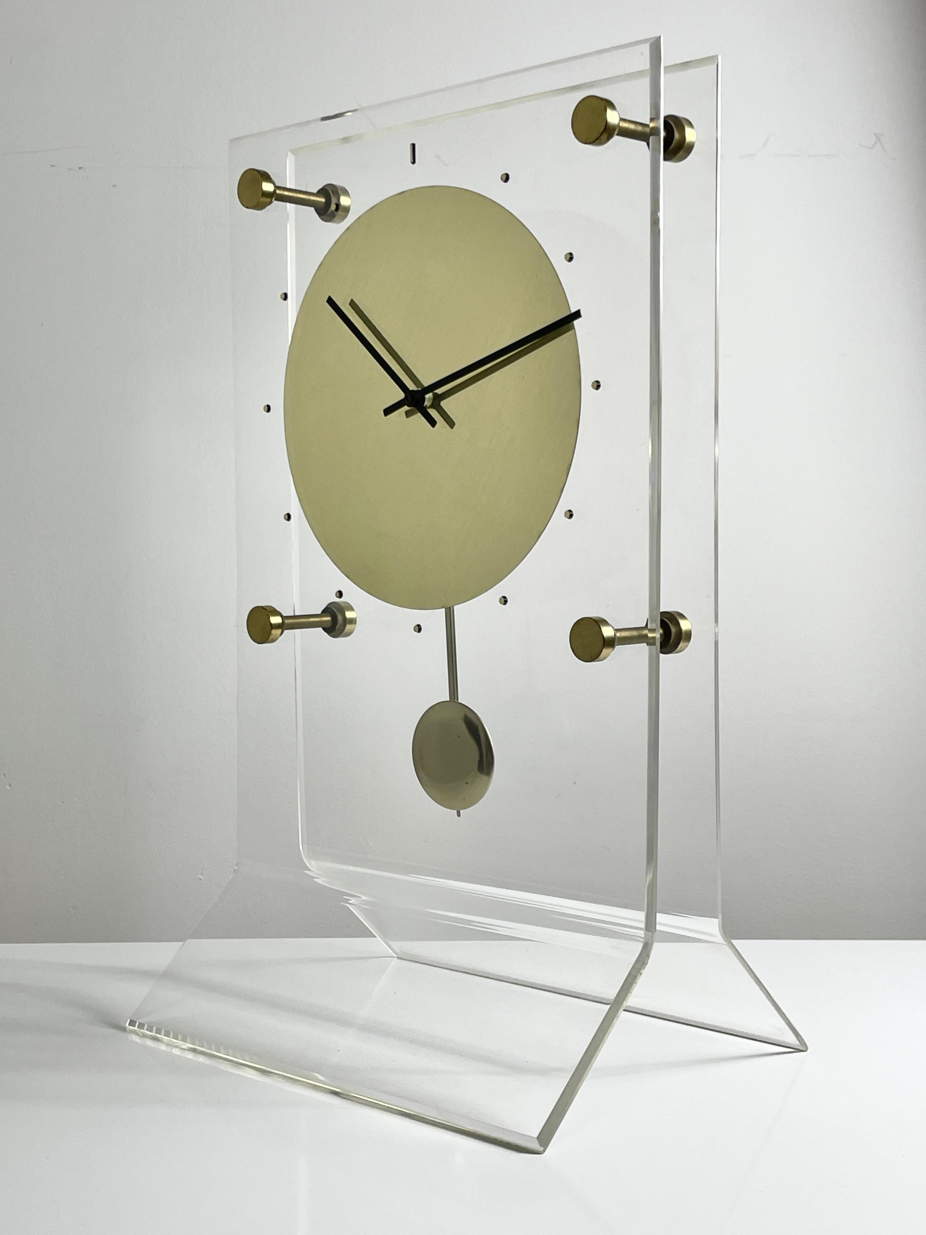 Large Vintage Lucite Brass Pendulum Mantel Clock 1970s

A rare lucite and brass mantel clock circa 1970s
Unique modern design with floating brass face and pendulum
Unmarked

Additional Information:
Materials: Lucite and Brass
Dimensions: 9.5
