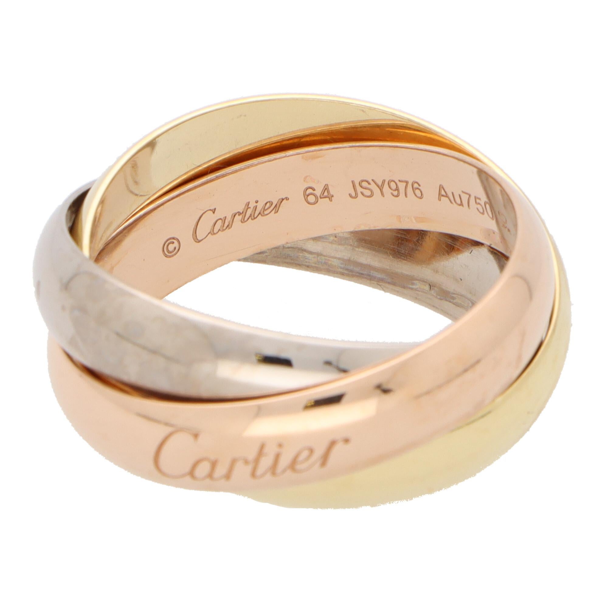 A classic Cartier trinity ring set in 18k yellow, rose and white gold.

The ring is composed of three interlinked 5.2-millimetre bands that are designed to roll with ease on the finger. The colour difference is subtle yet beautiful and the trinity