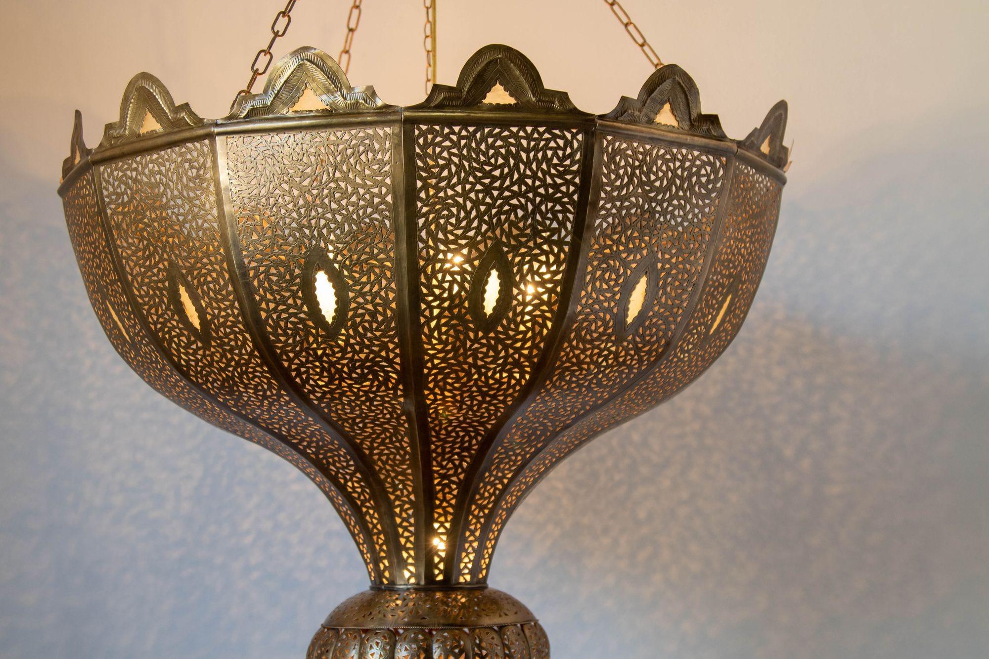 Vintage oversize exquisite brass filigree pierced Moroccan chandelier in Alberto Pinto Moorish Andalusian style.This exquisite vintage brass Moroccan chandelier brings a touch of North African elegance and craftsmanship to any space. Handcrafted