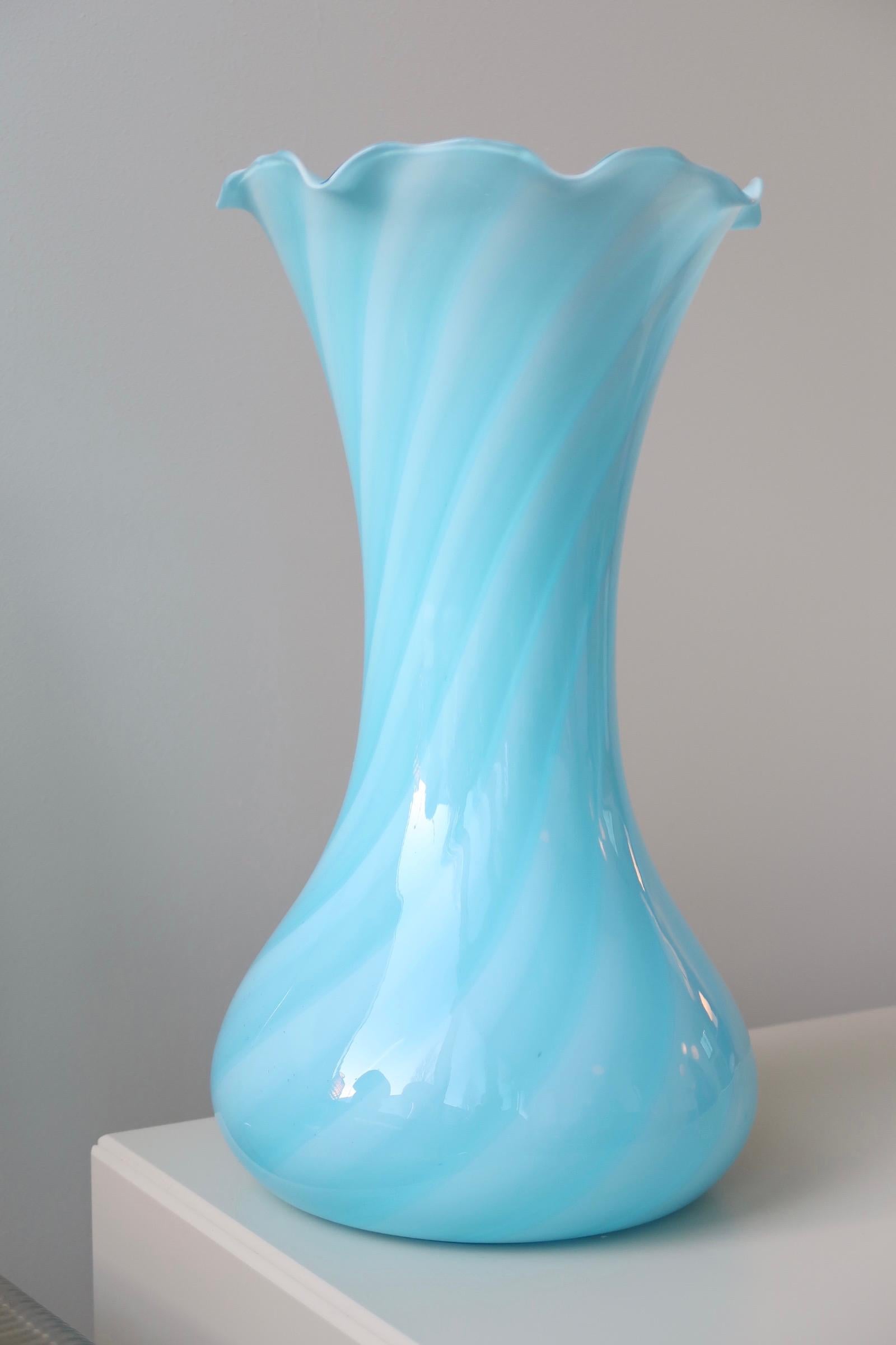 Extra large vintage Murano glass vase in a perfect light blue tone. Mouth-blown in blue glass with a swirl pattern and a beautifully finished edge. The vase is vintage and has a few signs of use, see pictures. Handmade in Italy, 1970s. H: 38 cm D: