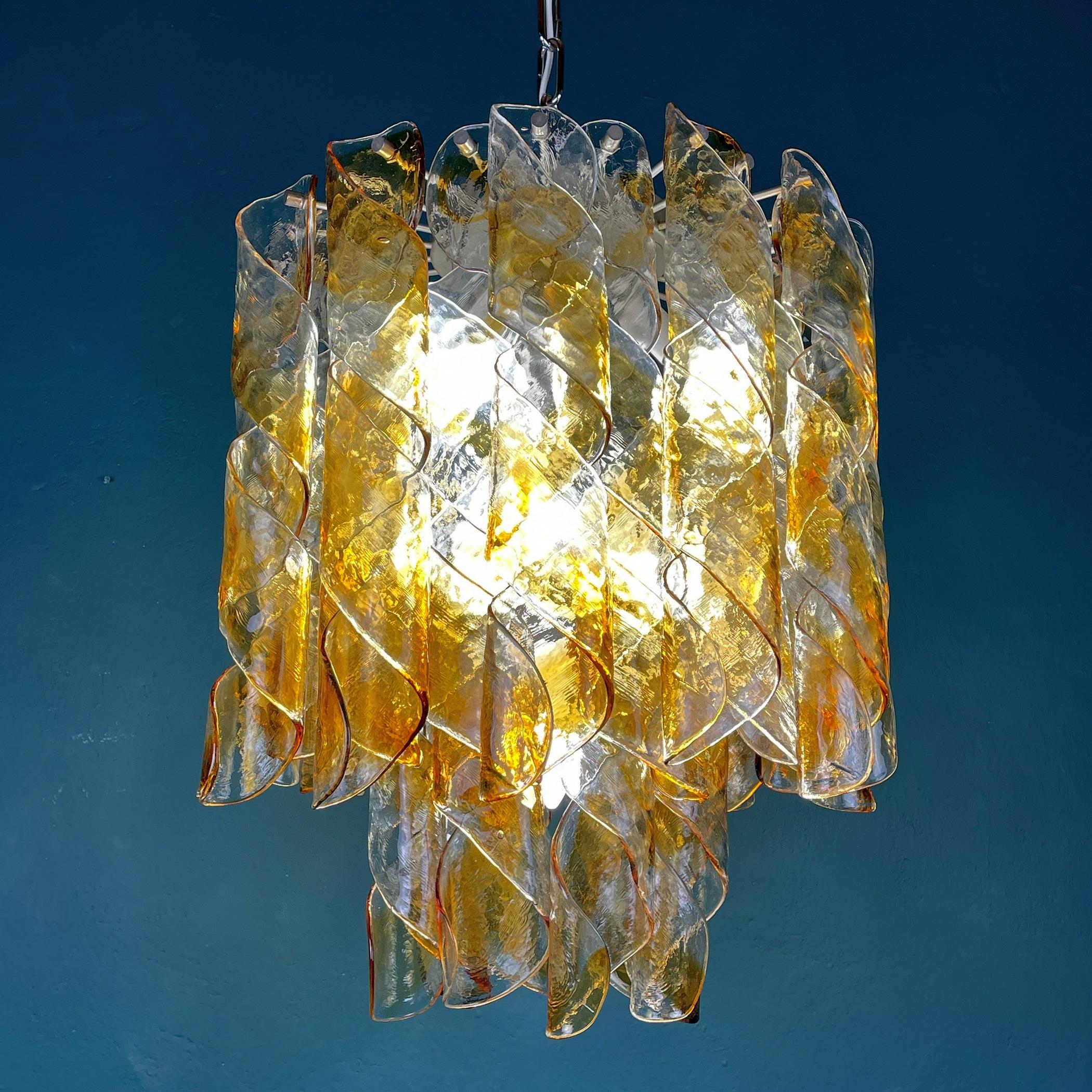 Gorgeous rare Murano glass chandelier by AV Mazzega made in Italy in the 1970s. Consists of 24 glass plates of Murano glass, 40 cm long, and 8 glass plates, 25 cm long made by Italian glassblowers. They follow the oldest Murano glassmaking