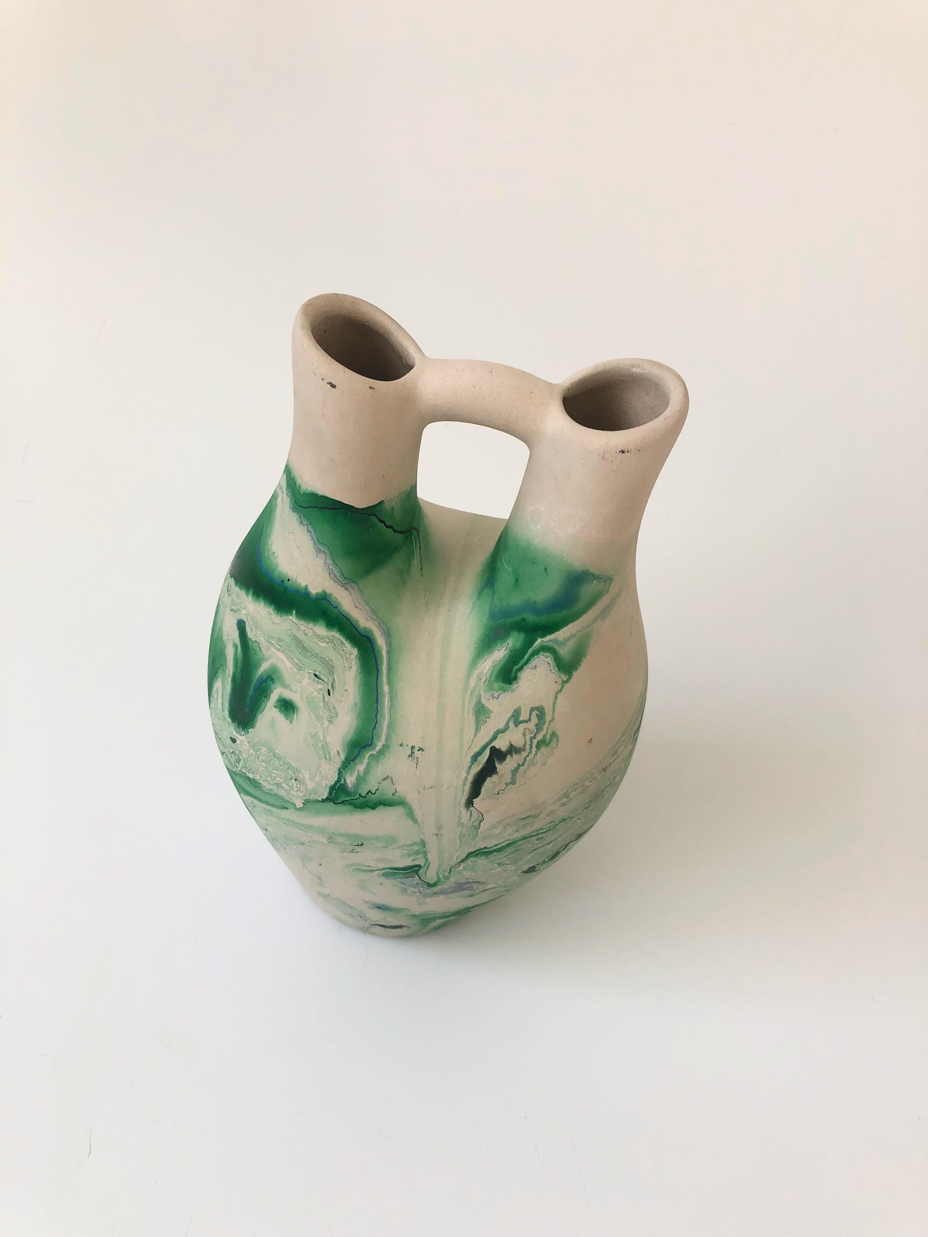 A large vintage Nemadji Pottery wedding vase with a beautiful organic pattern of green swirls on a light off-white background. Beautiful matte finish.
 