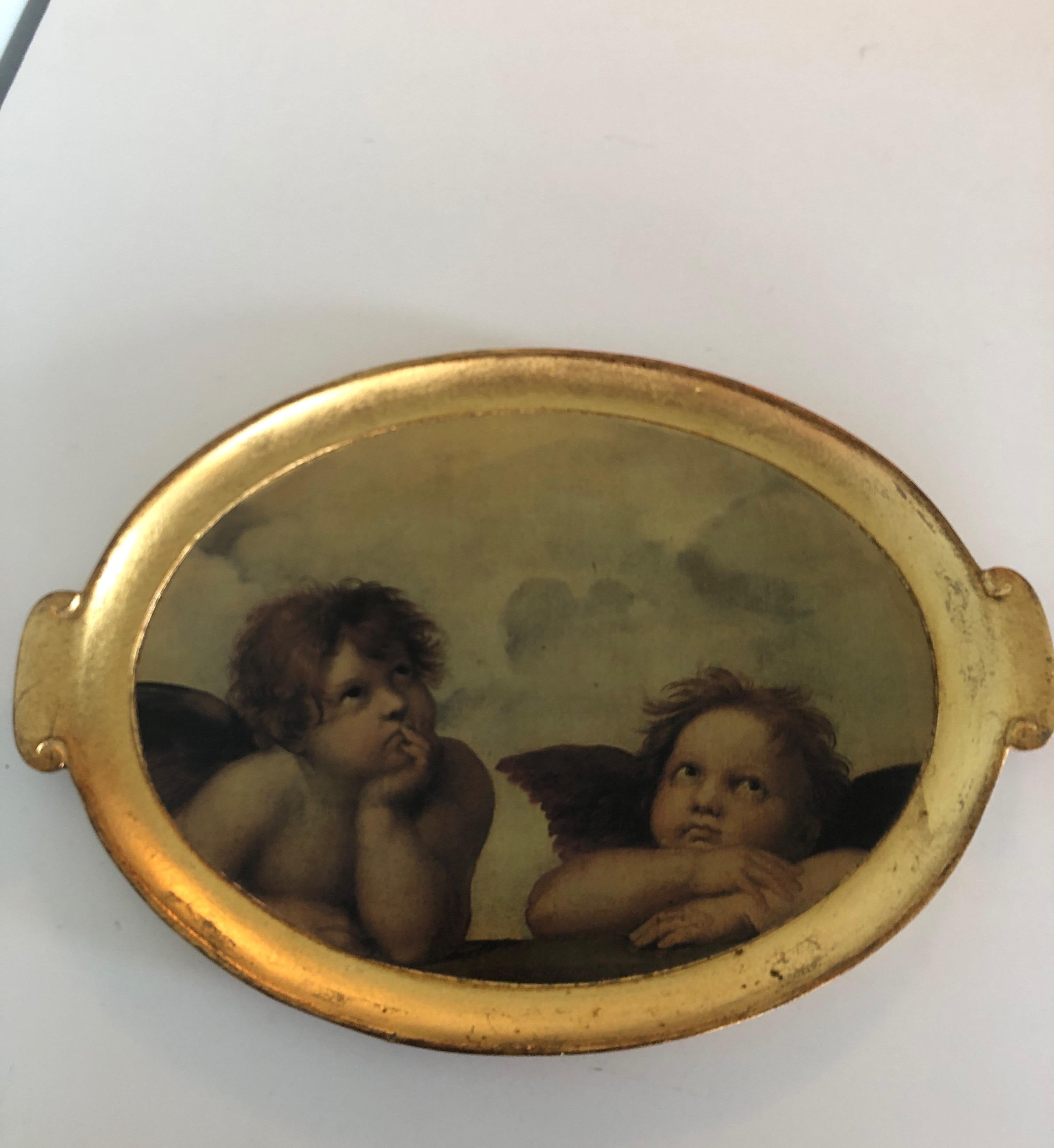 Vintage large oval gold leaf serving tray.
Wood tray depicting cherubs.
Stamped hand-painted, made in Italy.
Size: 17.25