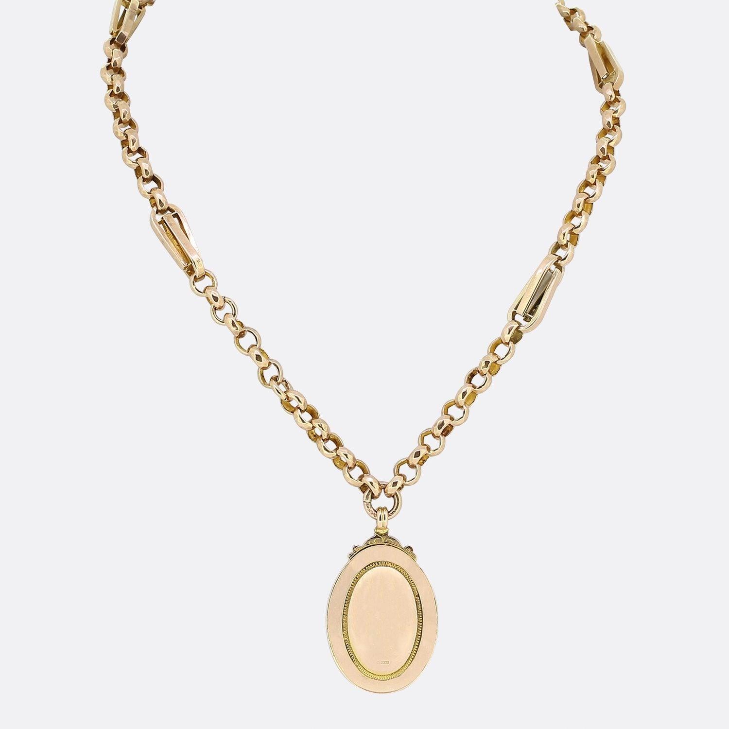 This is a vintage 9ct rose gold necklace. The necklace features a double layered oval shaped plain polished pendant with a geometric engraved boarder.  This piece is suspended from a fancy link chain and is secured with a vintage swivel