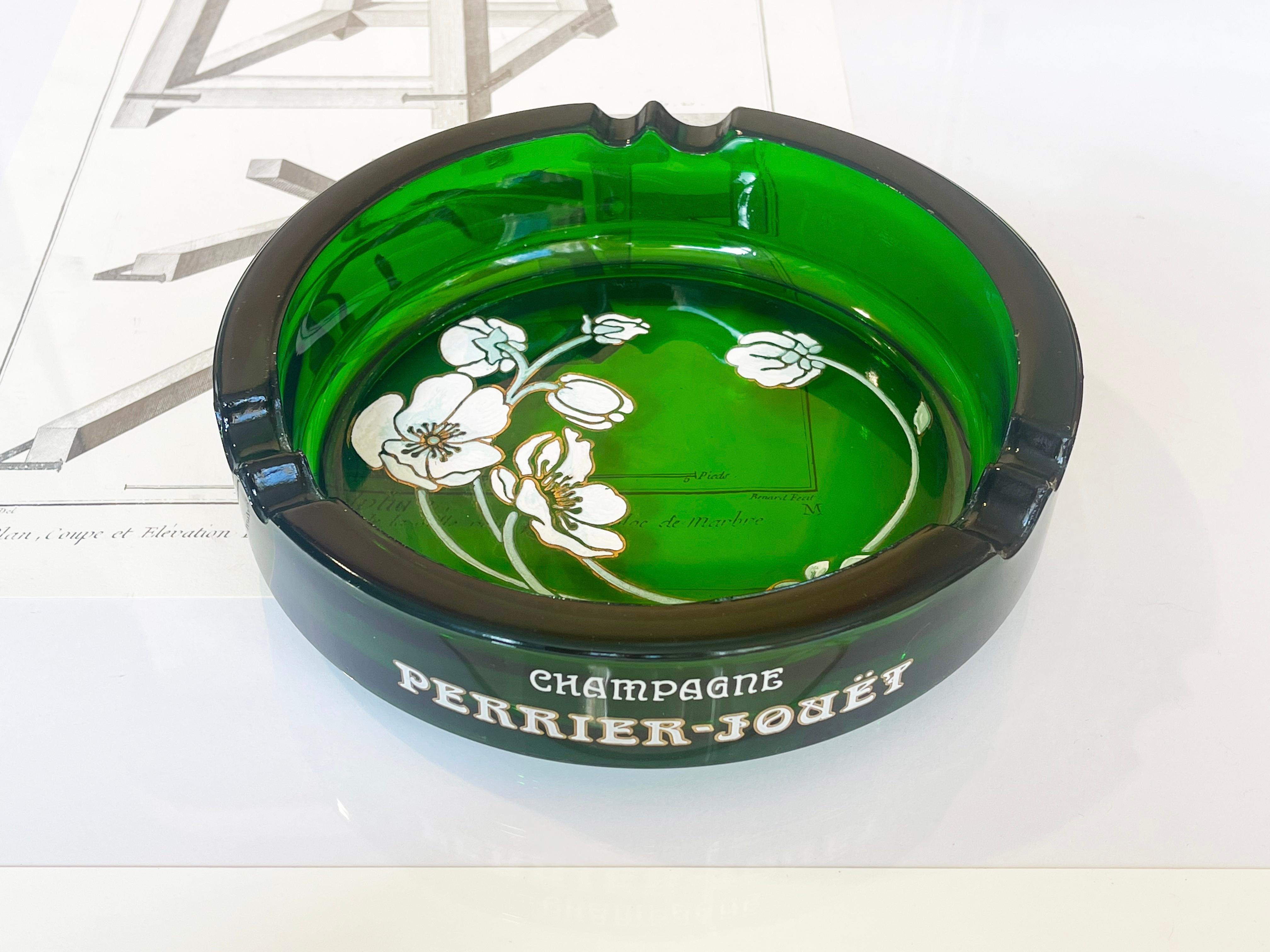 A very beautiful and very large vintage Perrier-Jouet French ash tray with iconic floral motif in the Art Nouveau style. The piece is substantial emerald green glass with raised enamel relief in mint & mild white to pink floral design with golden