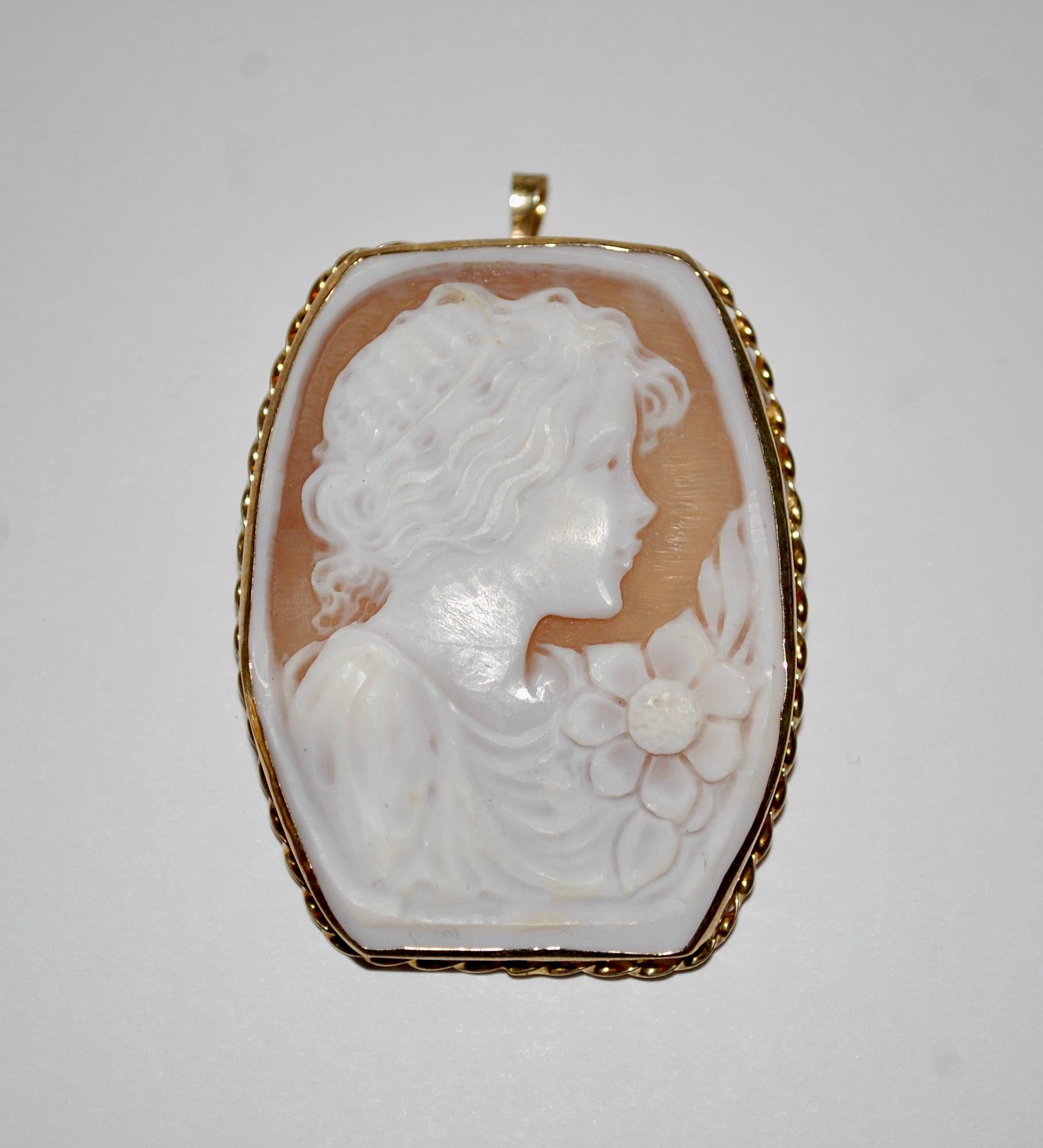 Vintage Large Cameo Pendent or Brooch.
Hand crafted with beautiful details  of a young lady with a flower. The almost squarish shell in light pink and white color set in gold plated 925 sterling silver, marked 925. A wonderful quality to showcase