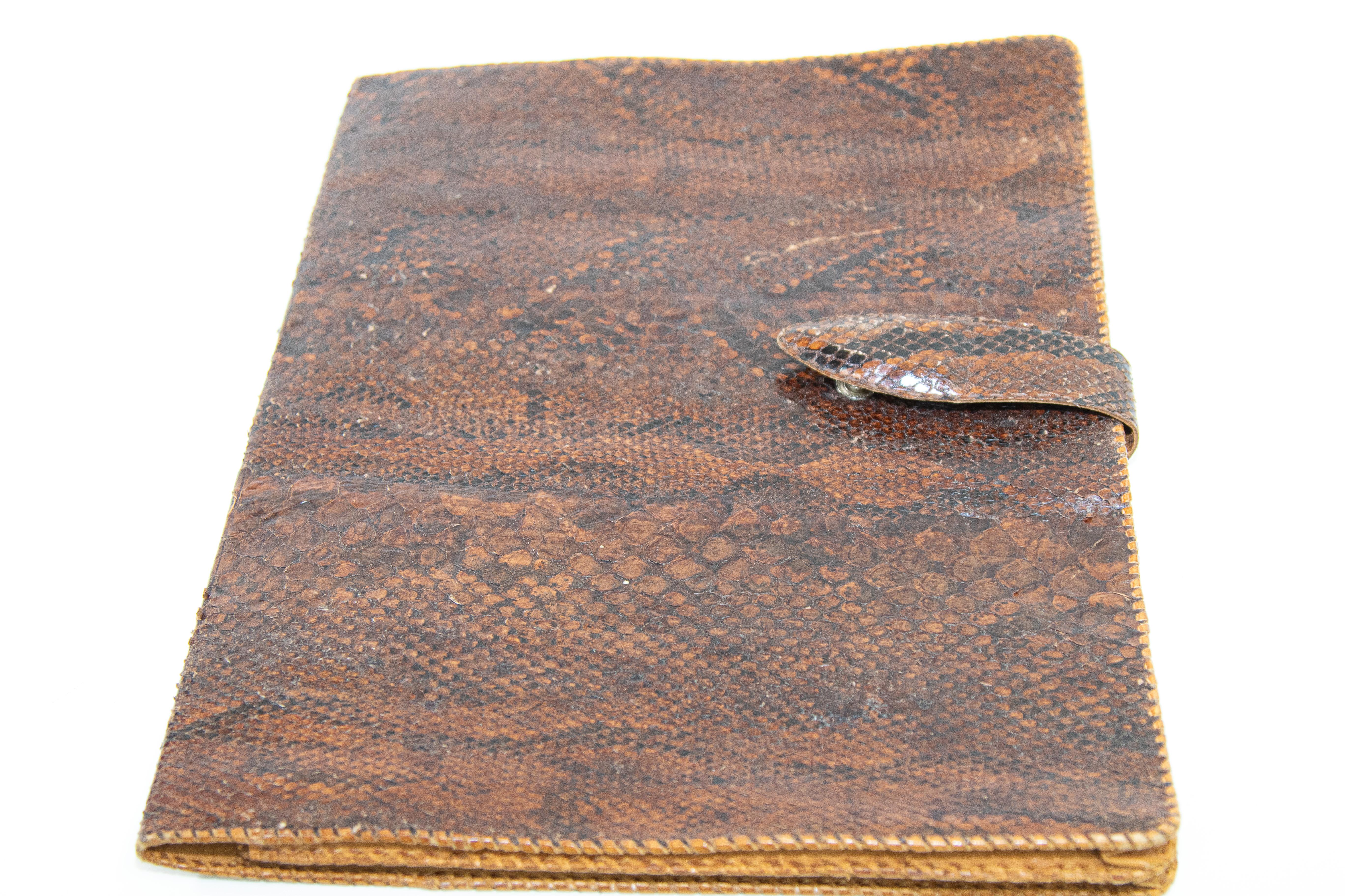 Vintage one of a kind 1950s large portfolio pad African snake skin in amber brown color.
Authentic vintage African snake leather portfolio purse in excellent condition.
The portfolio folds in half, it is finished at the edges in a whip stitch, the