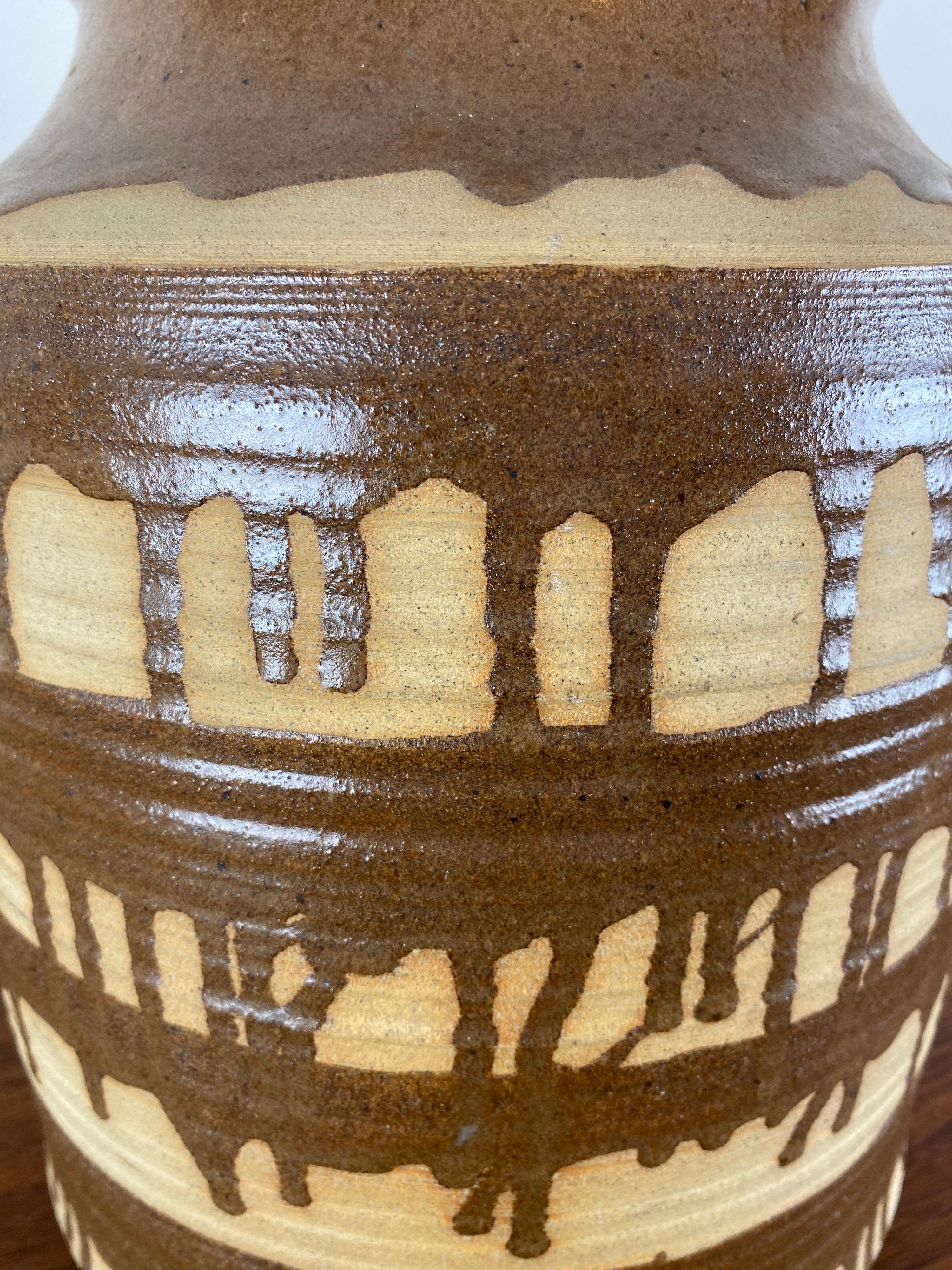 Vintage storage jar or decor crock. Cork lid with abstract striped glaze.

Free shipping.