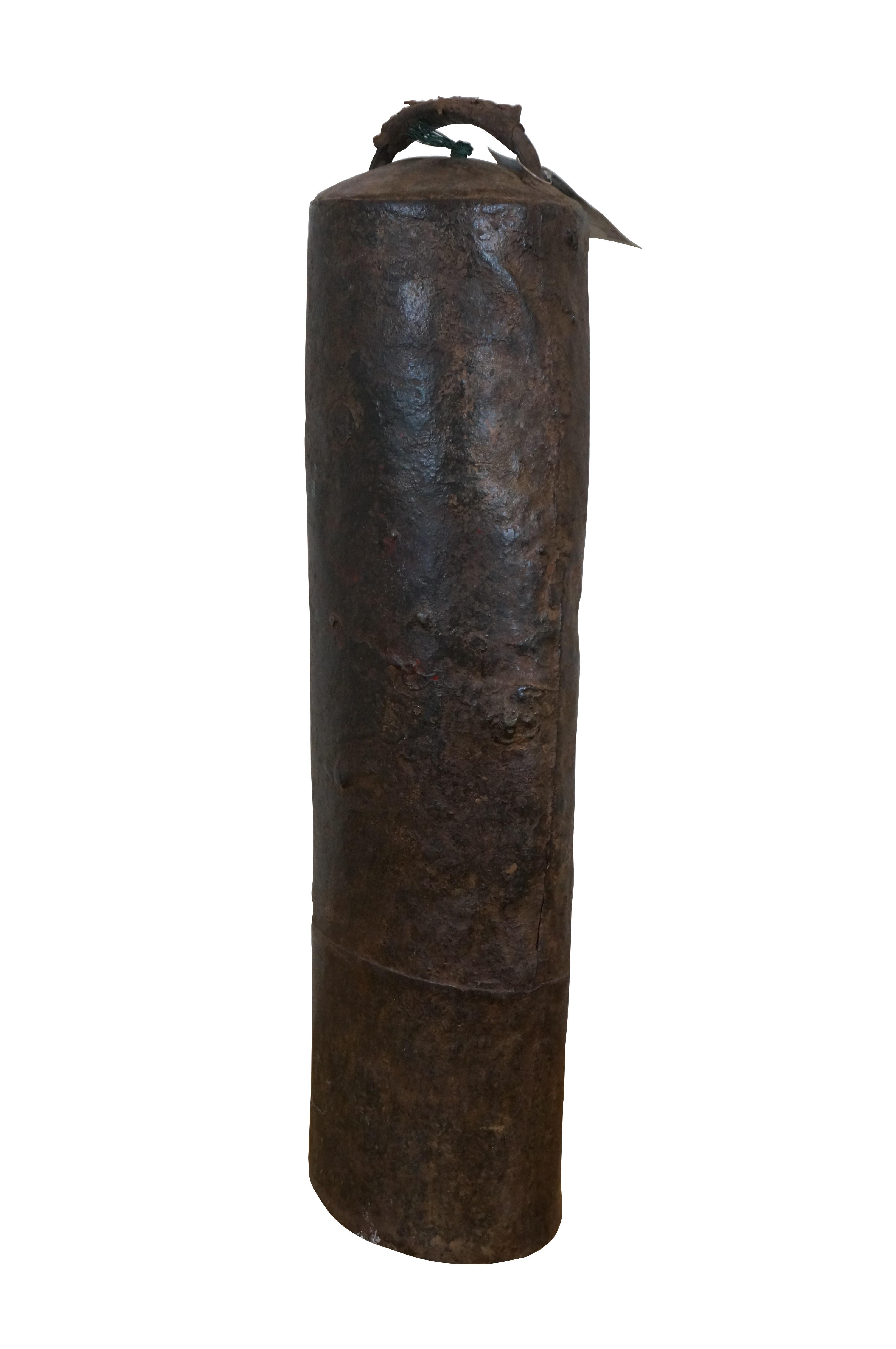Vintage iron camel / cow / horse / livestock bell (loutuo lingdang) - long, narrow, cylindrical form with a leather-wrapped handle on top and a brush-wrapped clapper.

Dimensions:
6.75