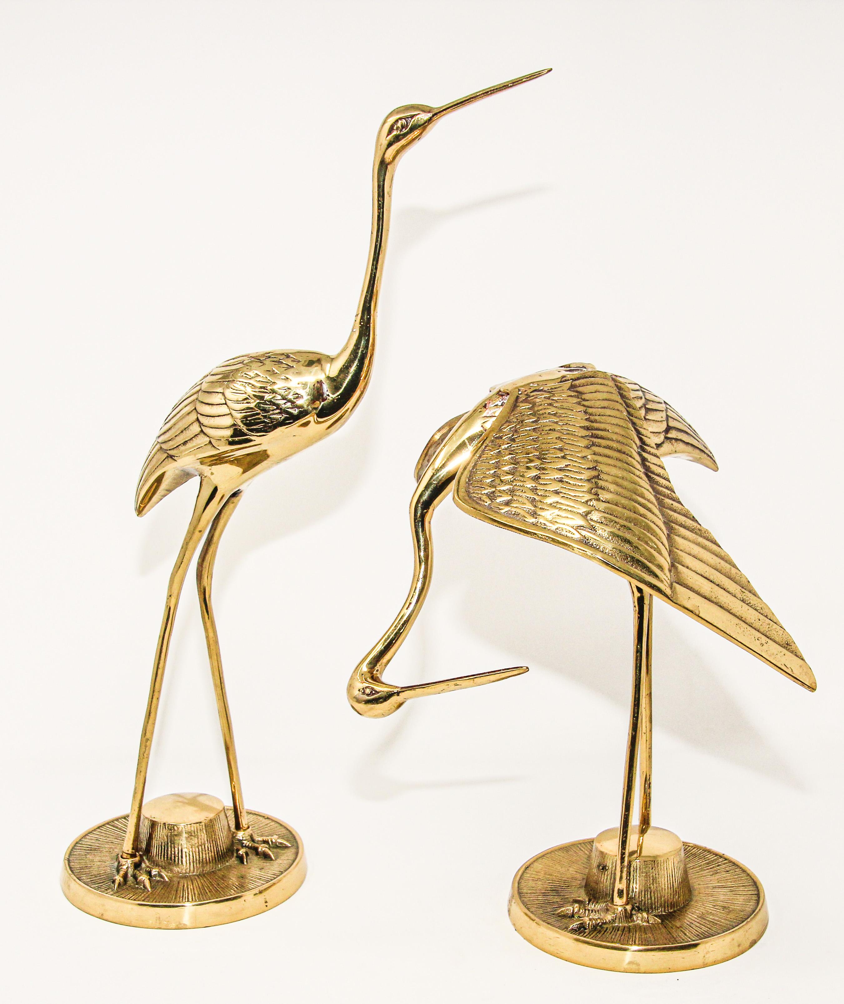 Set of two polished vintage cast metal solid brass heron crane figurines.
Large scale Hollywood Regency Asian style solid polished brass heron bird sculptures.
These vintage pair of brass Asian inspired crane sculpture are the perfect pieces to