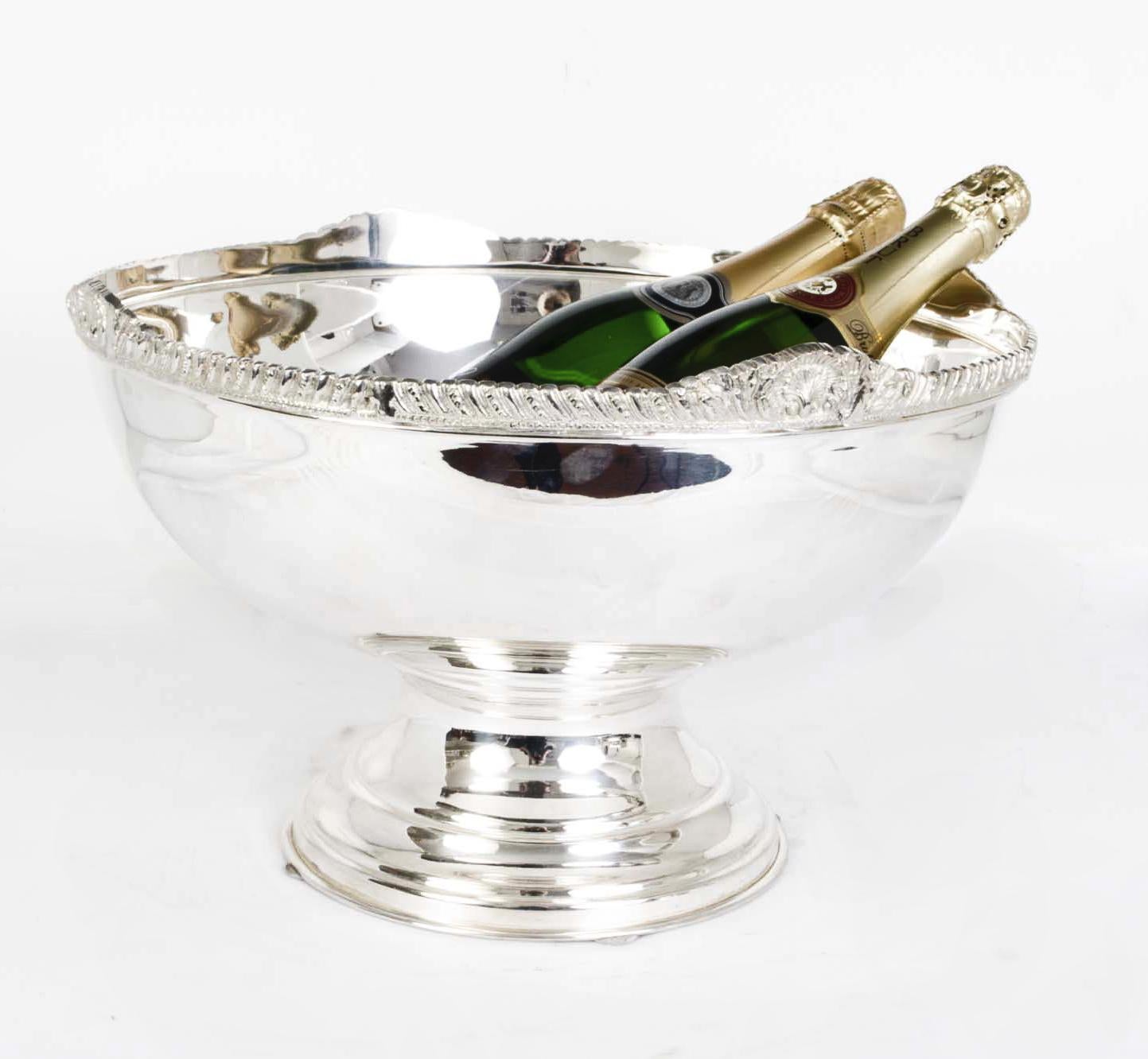 This is a beautiful large vintage silver plated champagne cooler that can acommodate 6 bottles with ease.

The quality and craftsmanship are superb and the bowl features beautiful gadrooned decoration around the top.

Add a touch of style to