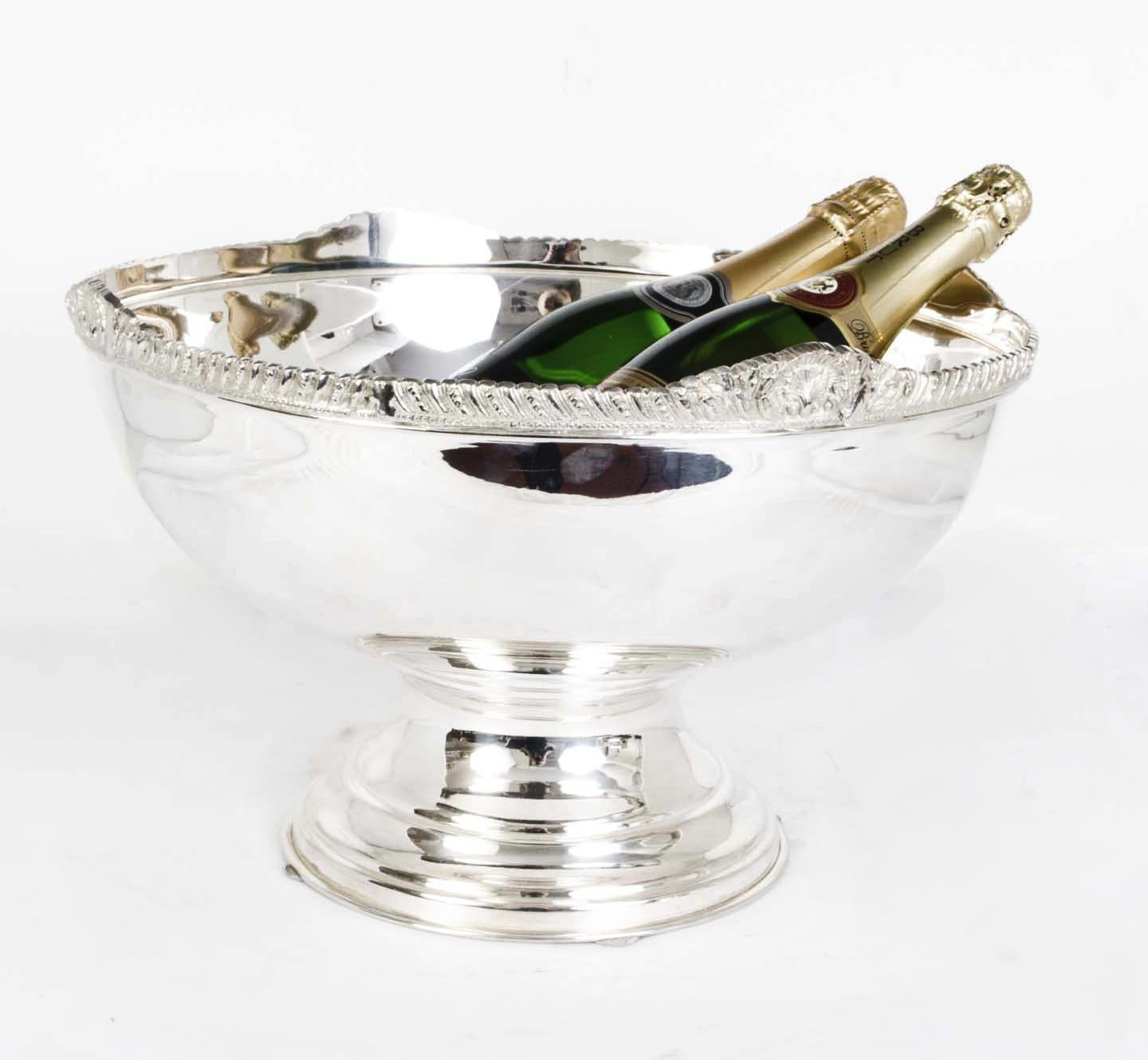 This is a beautiful large vintage silver plated champagne cooler that can acommodate 6 bottles with ease.

The quality and craftsmanship are superb and the bowl features beautiful gadrooned decoration around the top.

Add a touch of style to your