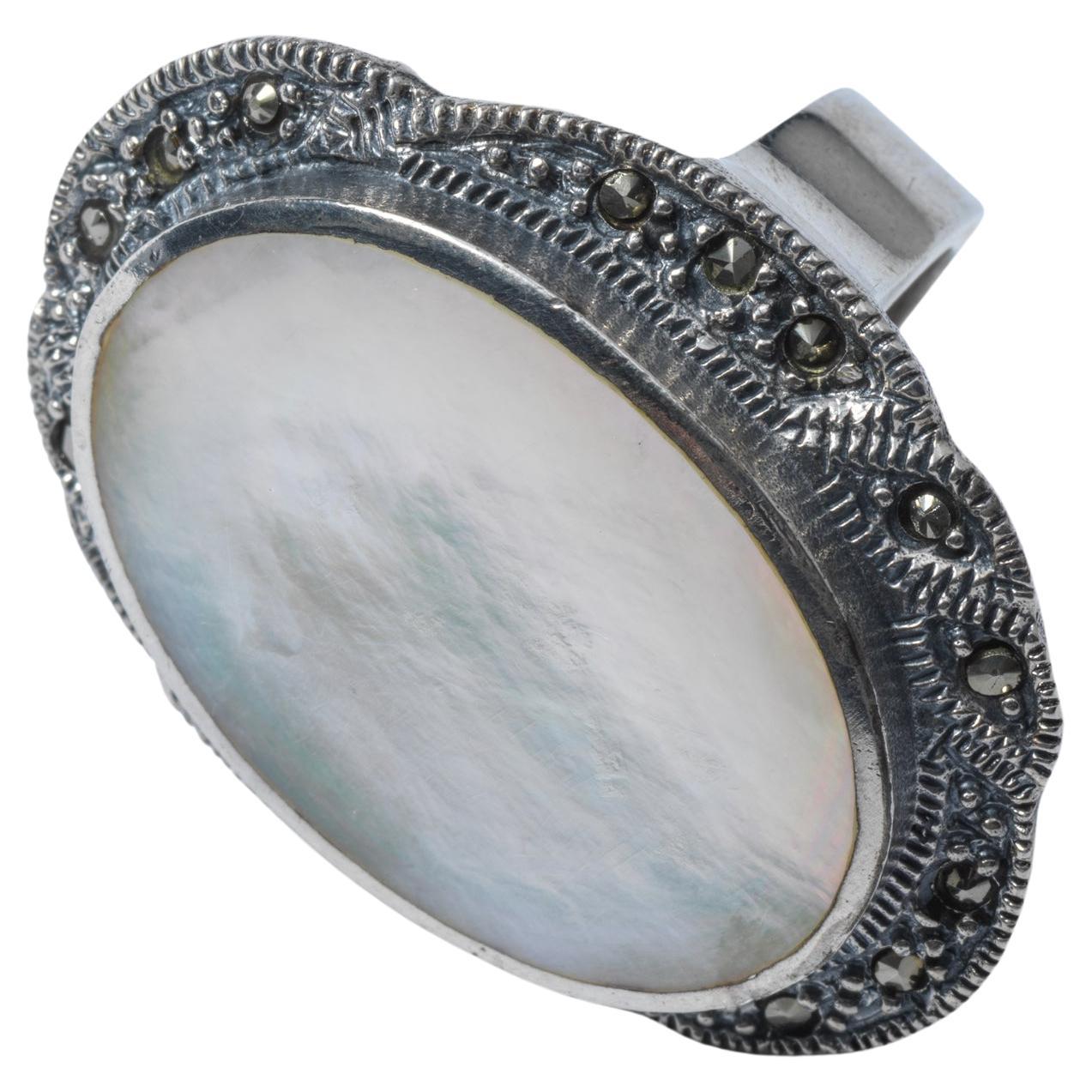 A large beautiful ring that makes a statement, this is the one. The large oval shaped mother of pearl is set in silver with small pyrites. Its made in the first half of the 20th c in northern Europe. If worn by an elderly person it will fit well and