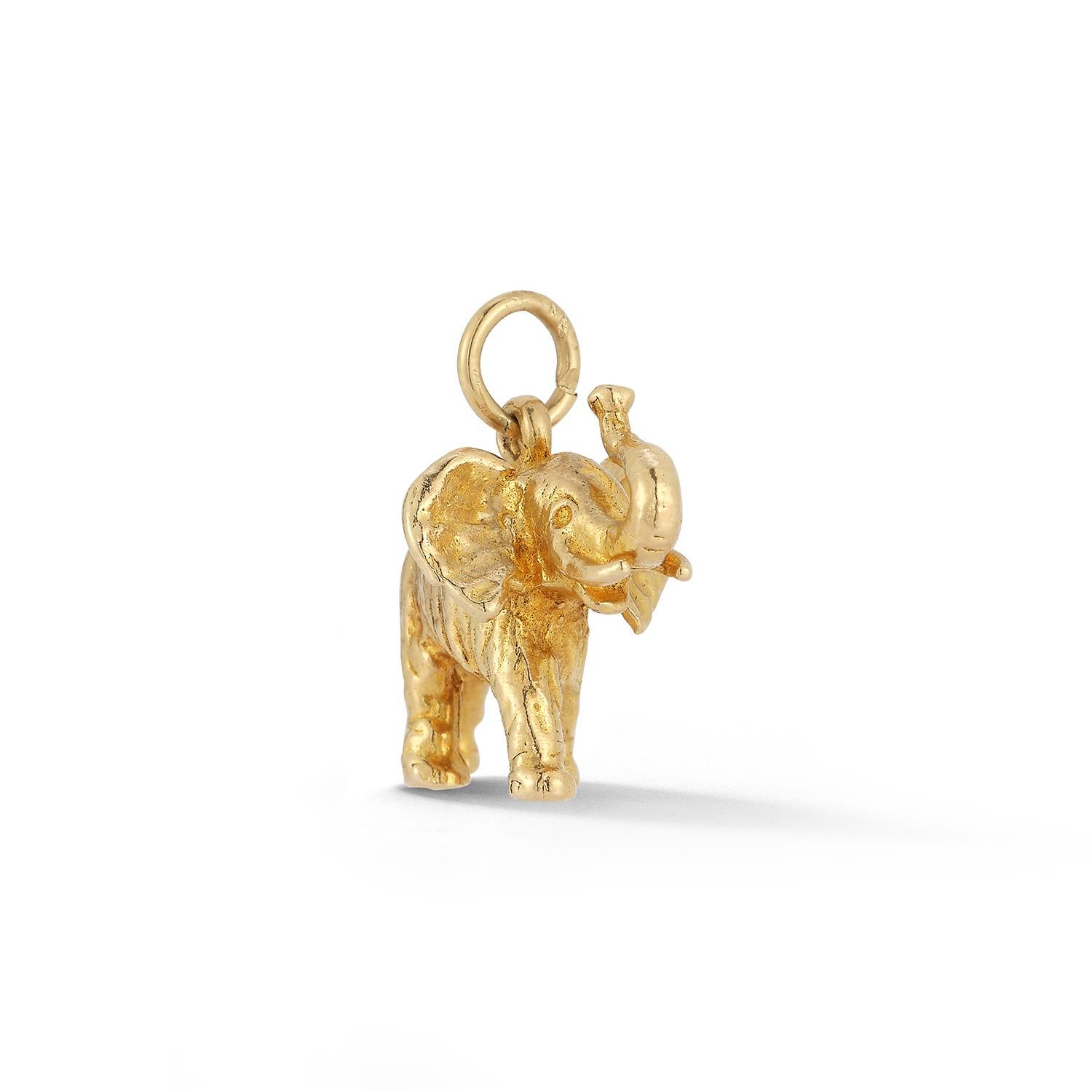 A large solid gold and detailed elephant charm with its trunk pointed upward for good luck. 

We also have a smaller version for mother and child as seen in the photos. 

Wear it on a chain or add it to a favorite charm bracelet. 

1