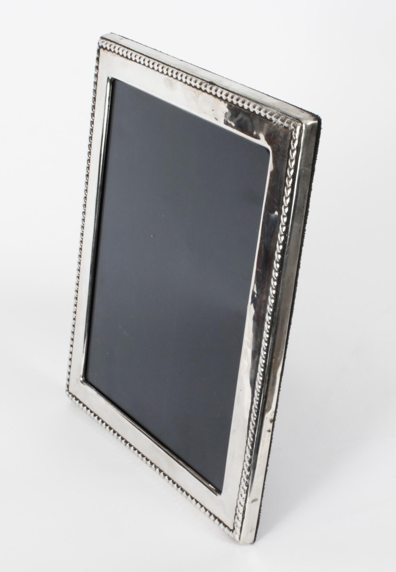 A truly superb large decorative sterling silver photo frame by A & J Zimmerman Ltd of Birmingham with hall marks for Birmingham 2012.

Beautifully portrait frame decorated with scaloped relief borders. 

An excellent gift idea for many occasions