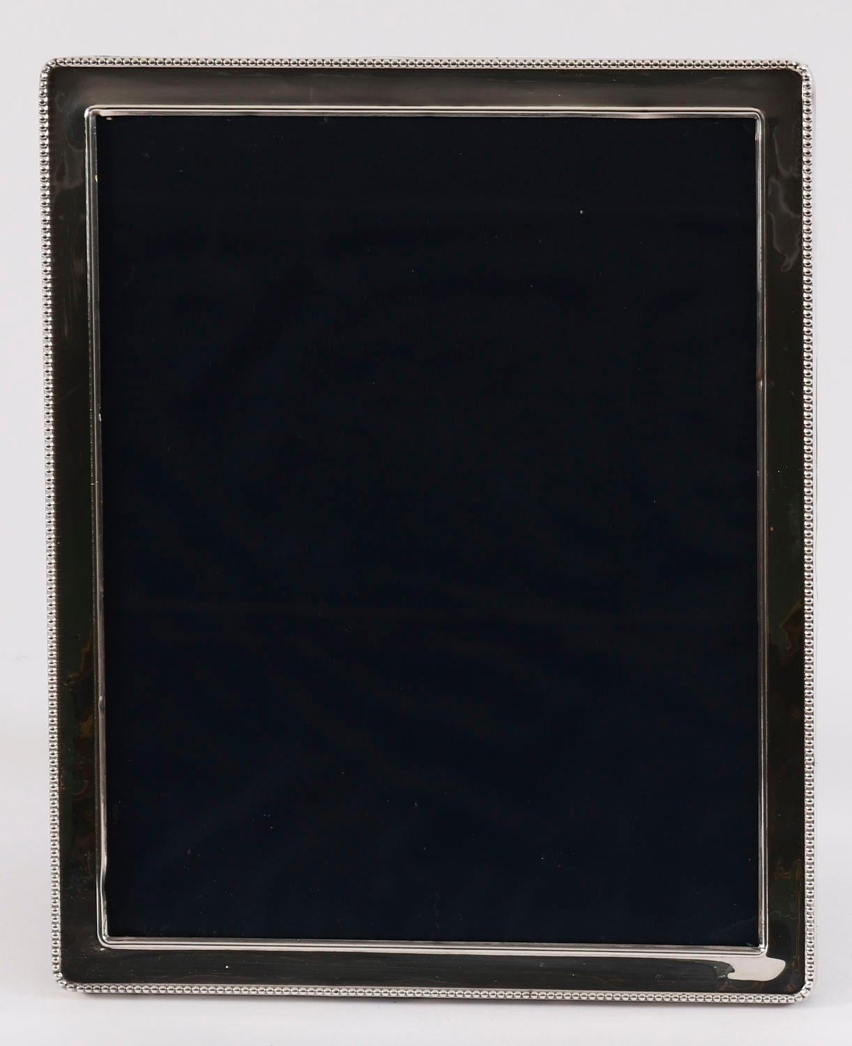 A truly superb large decorative Elizabeth II sterling silver photo frame with hallmarks for London 1990.

The rectangular frame features a beaded border and can be used portrait or landscape.

An excellent gift idea for many occasions or an elegant