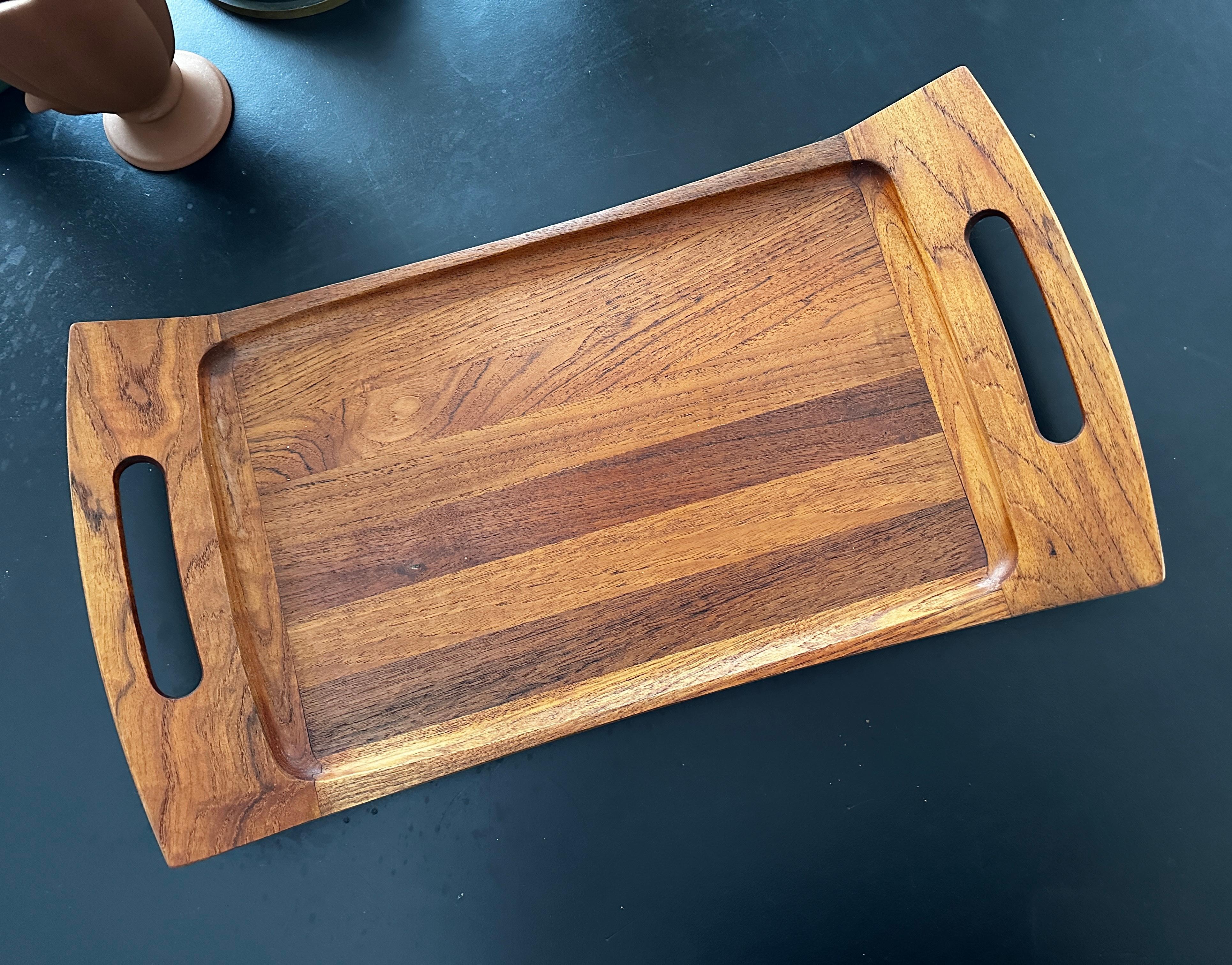 Vintage teak tray designed by Jens Quistgaard for Dansk in the 1960's.  The tray is signed on the back and measures 24.75 inches long, 12.75 inches wide and 2.75 inches high.
