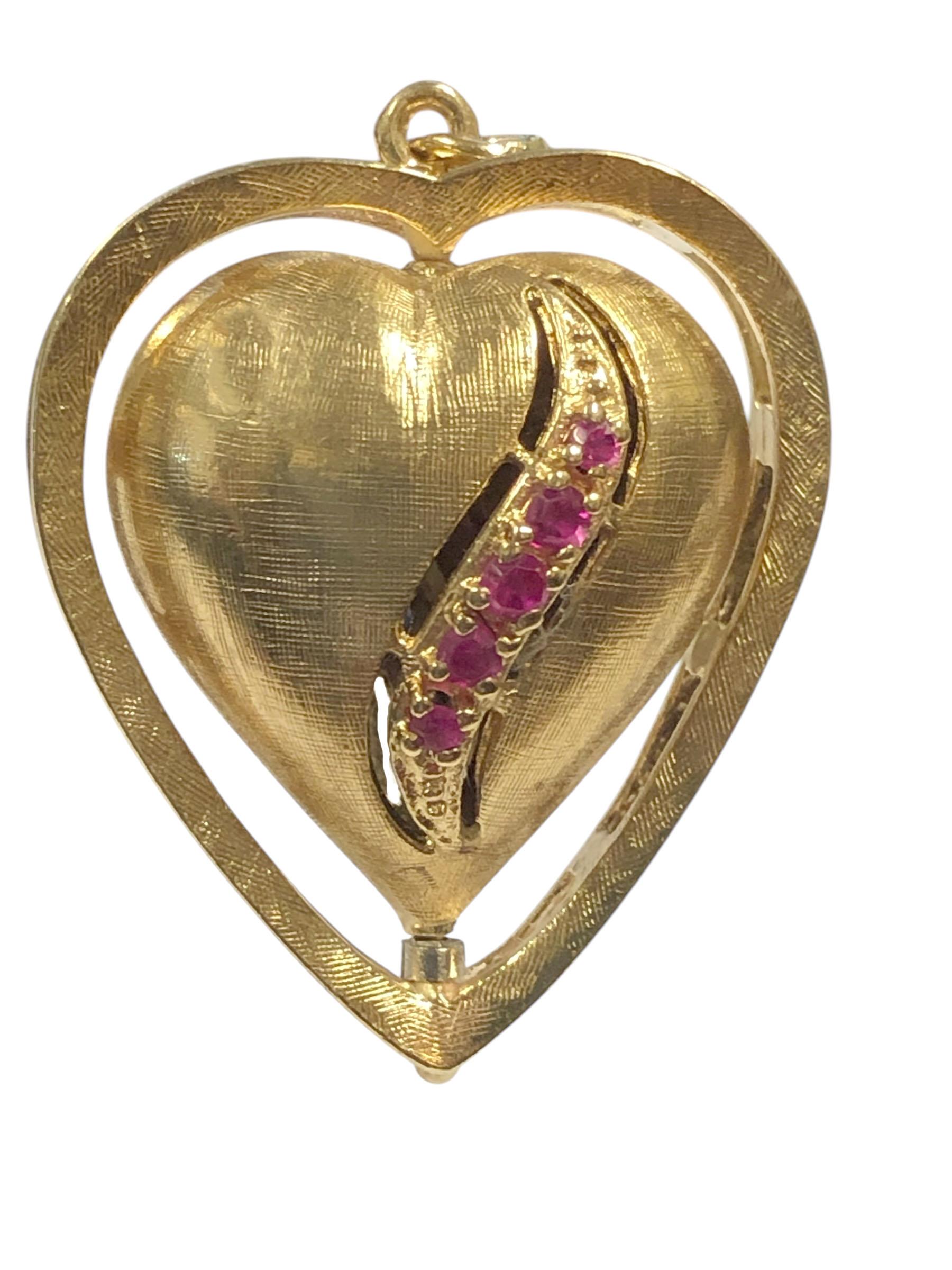 Circa 1950s large 14k Yellow Gold movable, spinning Heart Charm, measuring 1 1/8 inches in length,1 inch wide and 1/2 inch thick, the inner textured Puffy Heart spins within the outer Heart frame. set with Rubies and Sapphires and weighing 12.2