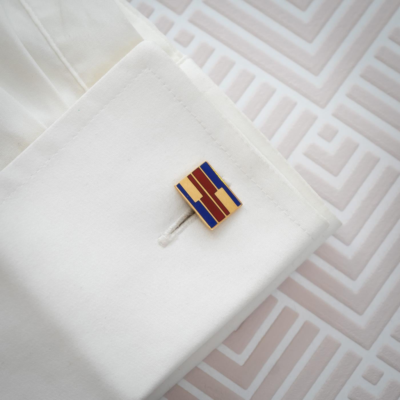 A pair of vintage Larter & Sons enamel and gold cufflinks, with red and blue enamel in a geometric design, on rectangular gold plates, mounted in 14ct gold, with the Larter maker's mark and 14K fineness marks on the bar fittings, American, circa