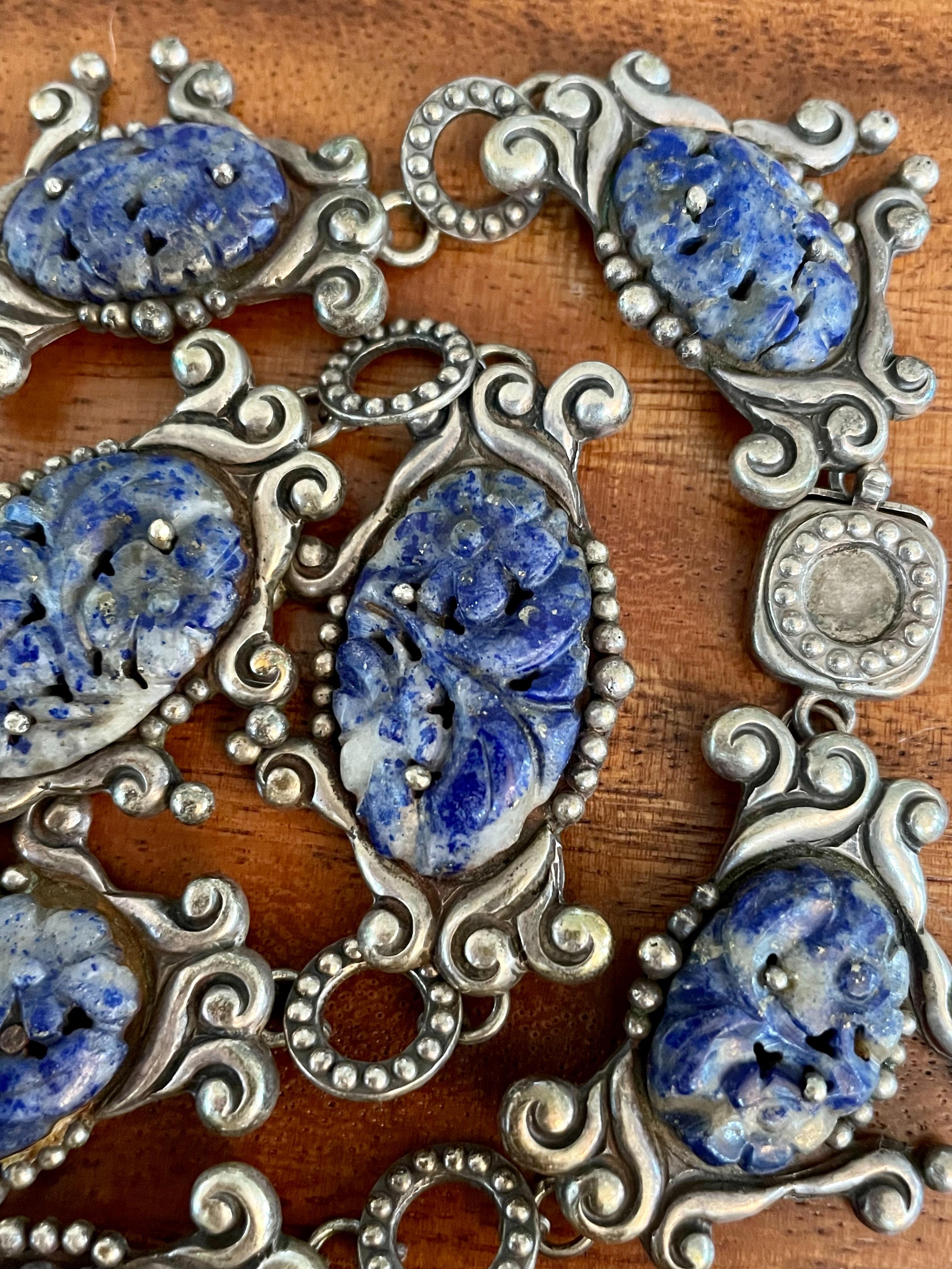 This amazing vintage Los Castillo sterling Silver necklace features eight carved Lapis Lazuli stones.  The closure is box clasp in fine working order.  

Stamped:  LOS CASTILLO TAXCO MADE IN MEXICO STERLING Numbered 555

Dimensions - approximately