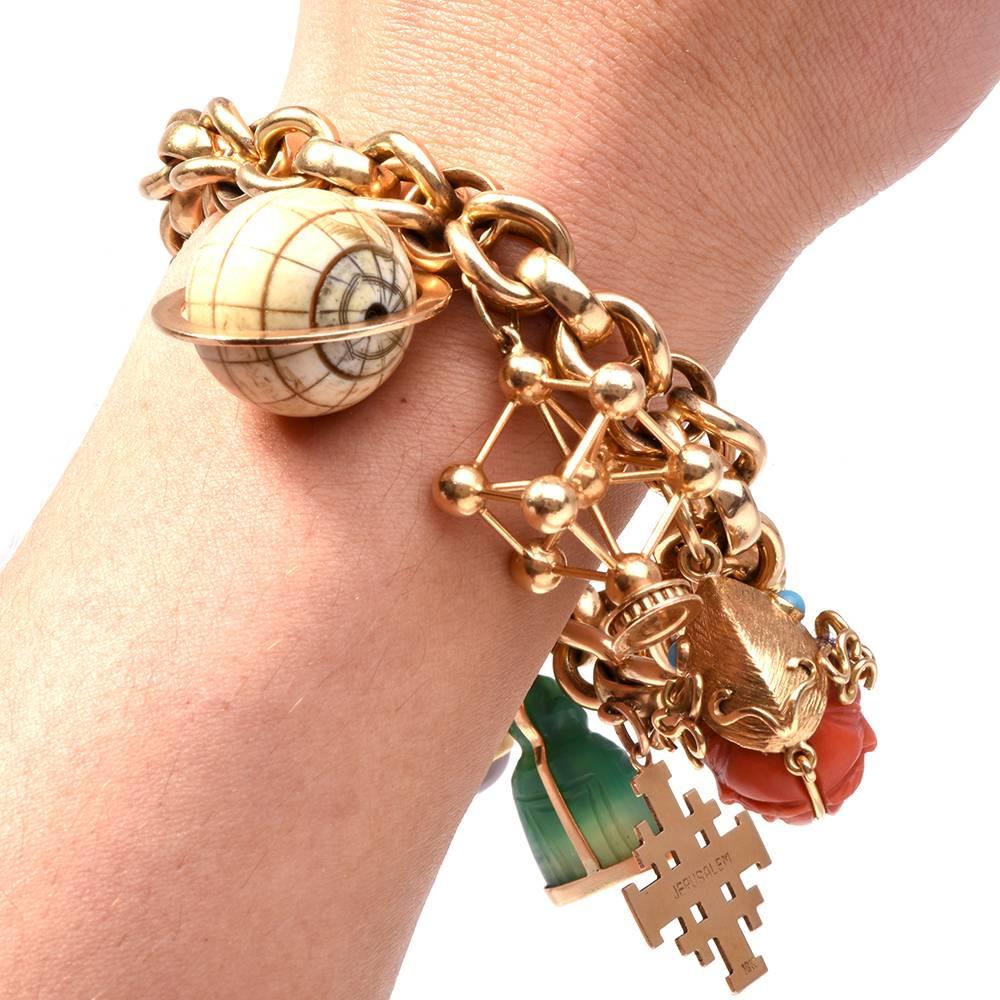 This Retro chic heavy charm Bracelet with multiple gemstones is crafted in solid 18-karat yellow gold. It weighs approx. 108.0 grams and measures 8 inches long. Incorporating an opulent chain composed of interlocking yellow gold links, the bracelet