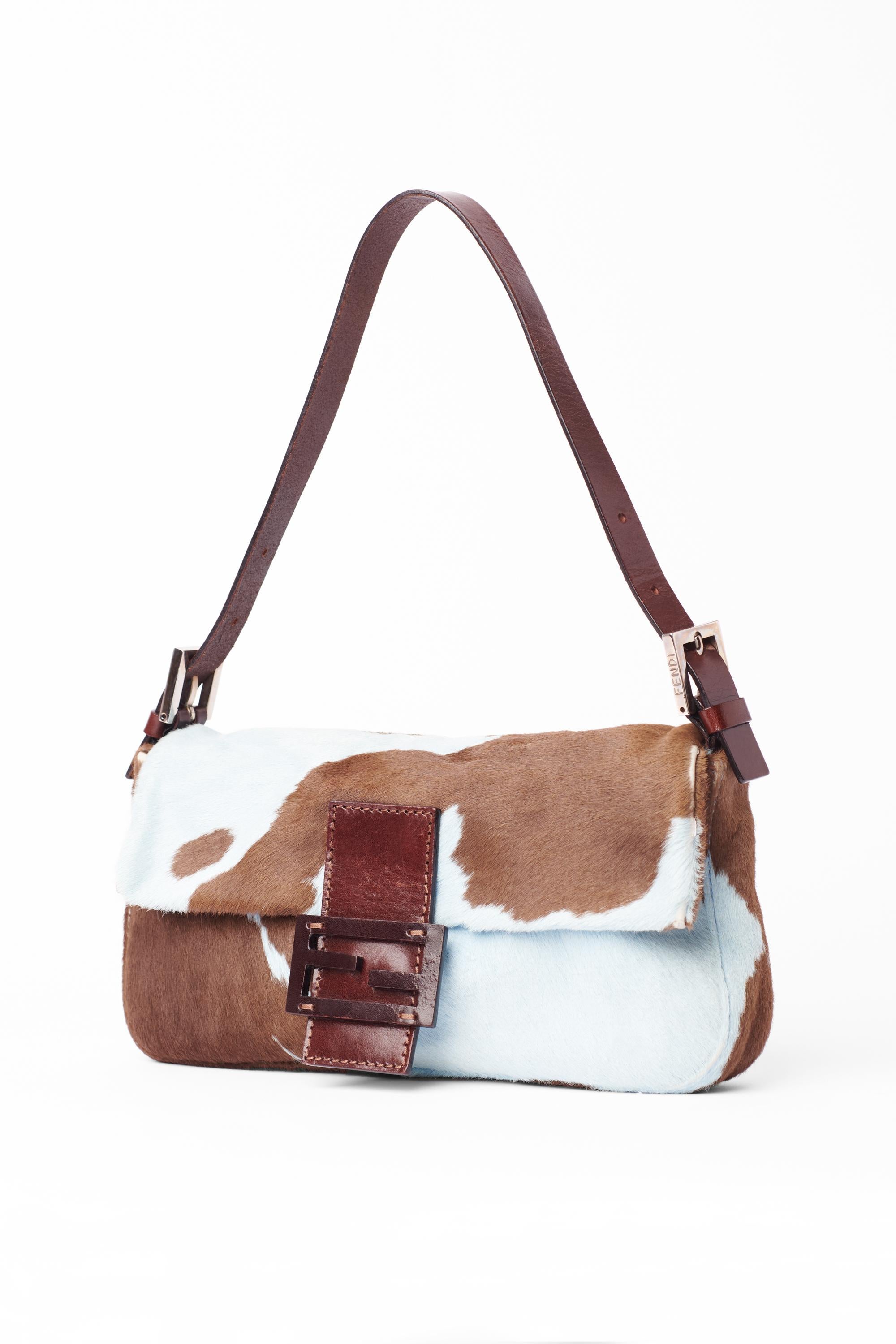 Vintage Fendi late 1990’s pony hair baguette. Features the rare blue and brown cow print allover in pony hair, adjustable leather strap with Fendi branded hardware buckles, iconic Fendi leather and metal front flap with magnetic closure and inner