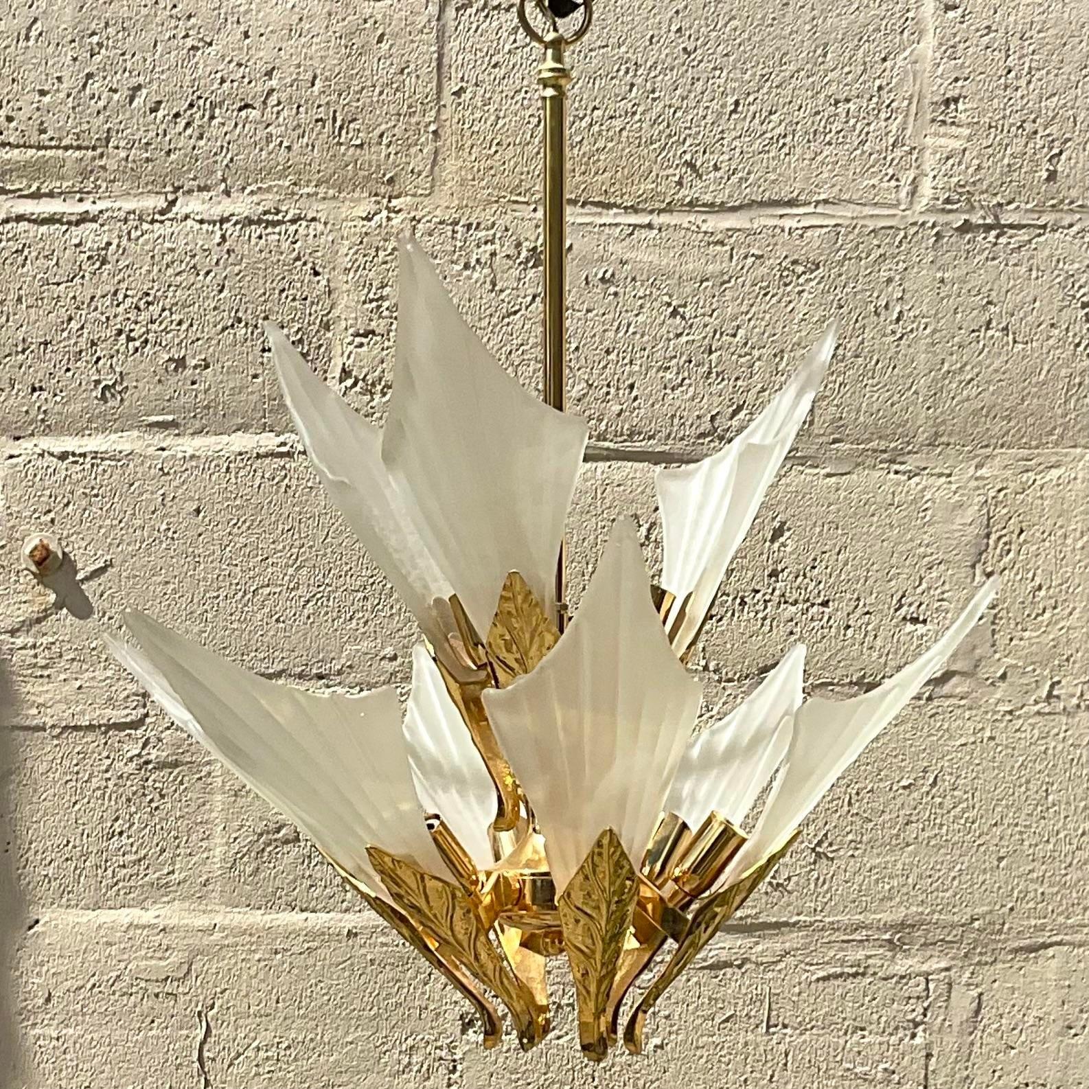 A fabulous vintage Boho chandelier. A chic frosted glass leaf design with brass leaf detail. Made by the iconic Murano group. Acquired from a Palm a each estate.