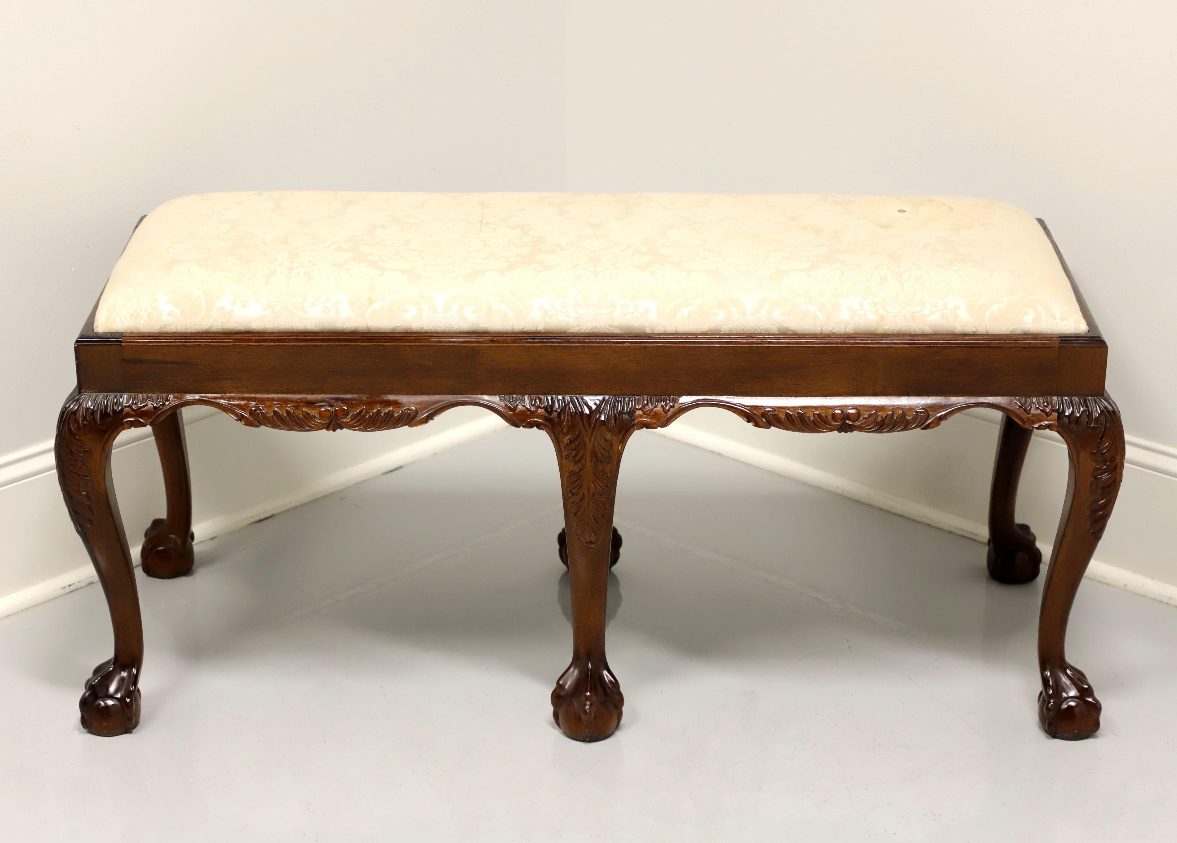 A Chippendale style bench, unbranded, similar quality to Hickory chair. Solid mahogany with carved apron & knees and ball in claw feet. Upholstered seat in a neutral cream brocade fabric. Made in the USA, in the late 20th Century.

Measures: 44 W
