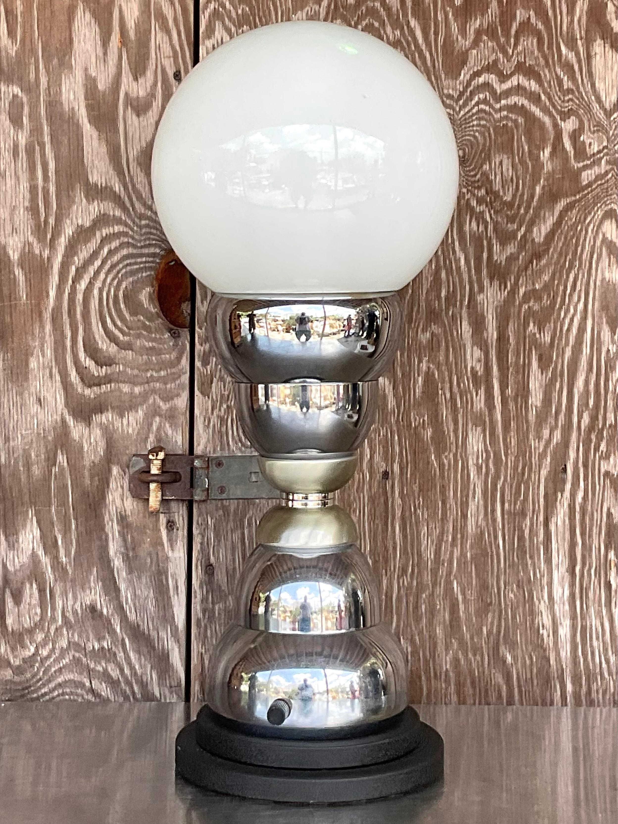 A fantastic vintage Postmodern table lamp. A chic stacked chrome with a large white globe. Acquired from a Palm Beach estate. 