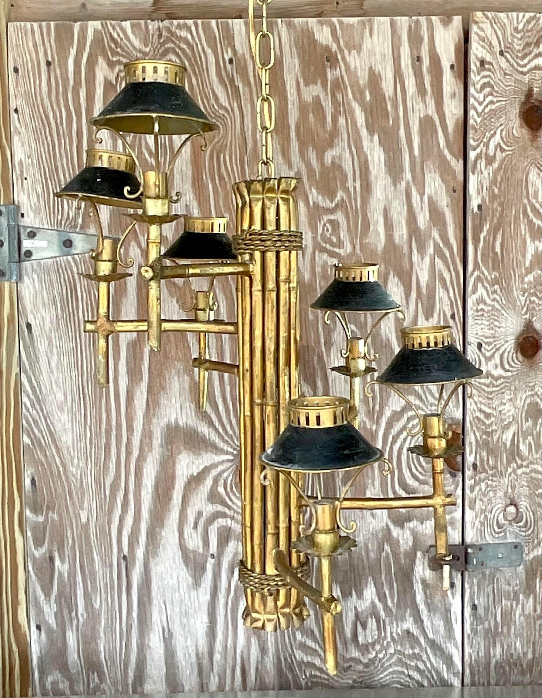 A fabulous vintage Regency spiral chandelier. A chic gilt bamboo center post with a spiral ring of small lanterns. Perfect in a tall stairwell! Acquired from a Palm Beach estate.