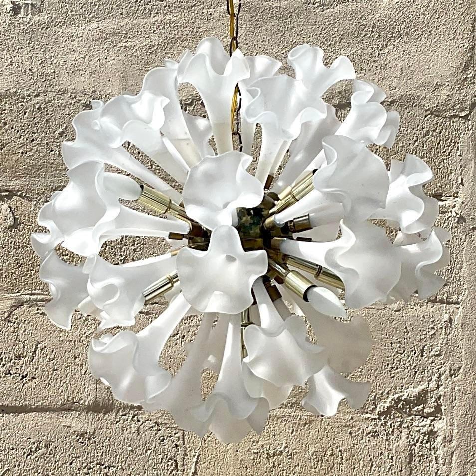 A striking vintage Regency chandelier. Made by the iconic Murano group. A chic frosted glass floral design on a brass globe center. Acquired from a Palm Beach estate.