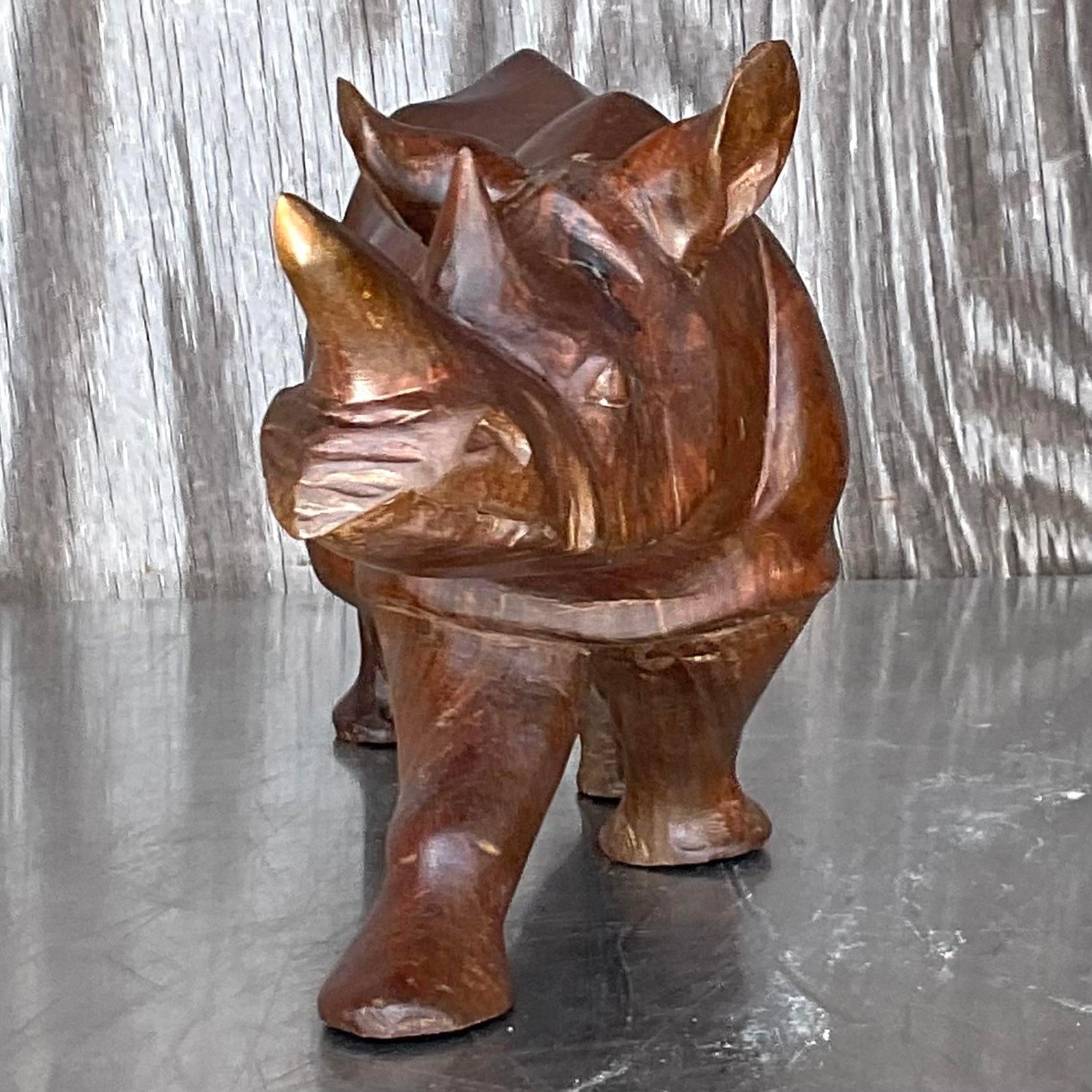 A fabulous vintage Boho rhino sculpture. A chic solid wood specimen with beautiful attention to detail. Acquired from a Palm Beach Estate.
