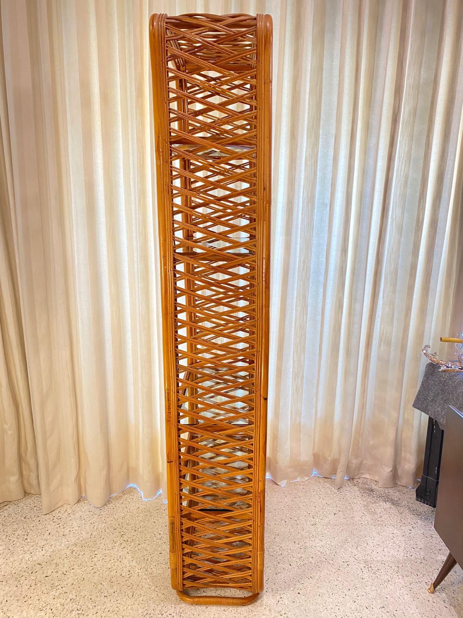 5 shelves and all original, this natural rattan and bamboo etagere with beautiful lattice side panels and base.