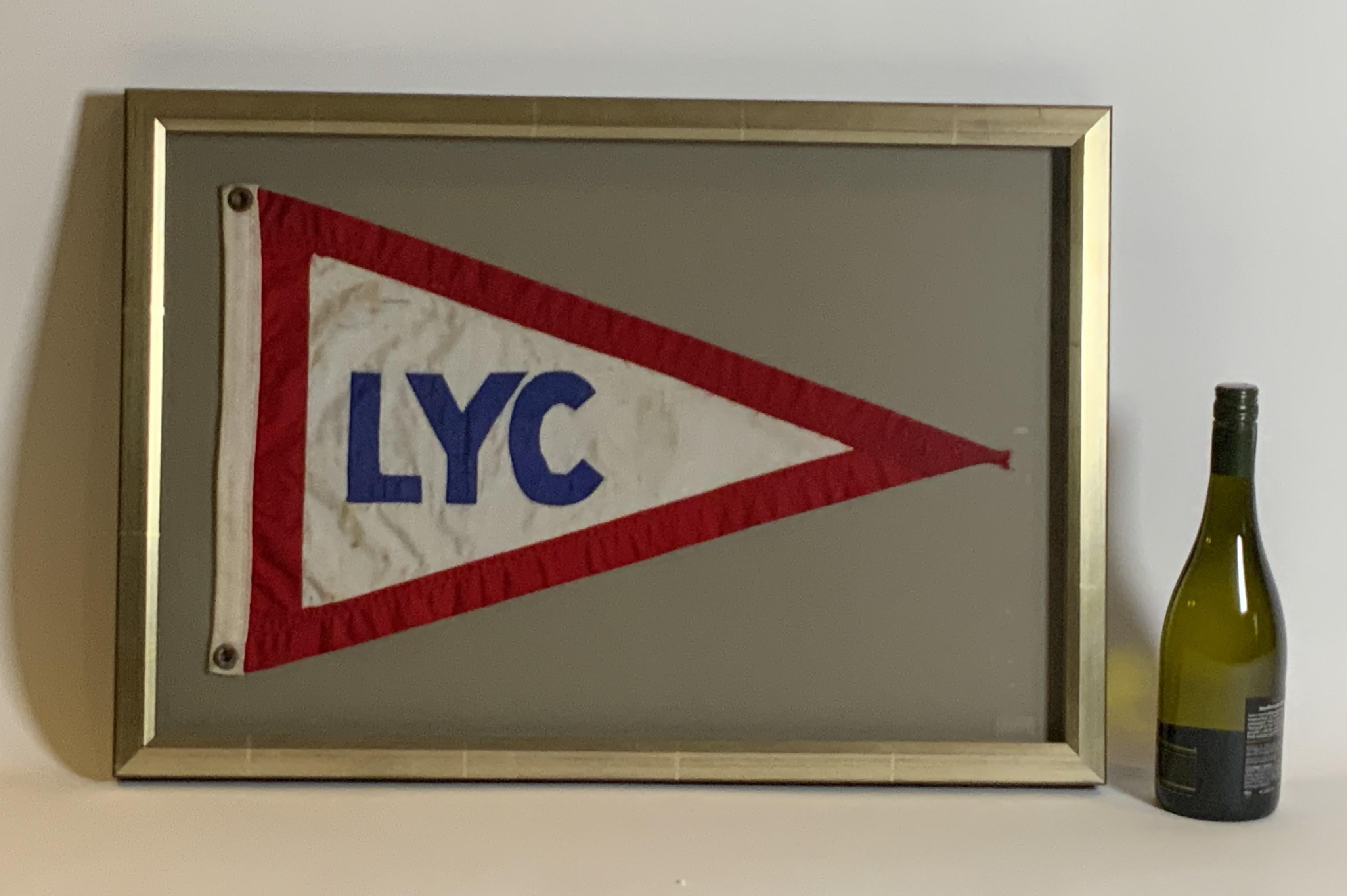 Linen nautical flag from the Lauderdale Yacht Club. With brass grommets. Shows use on the ocean. Custom frame with gray mat.

Weight:    7 lbs.
Overall Dimensions:    19
