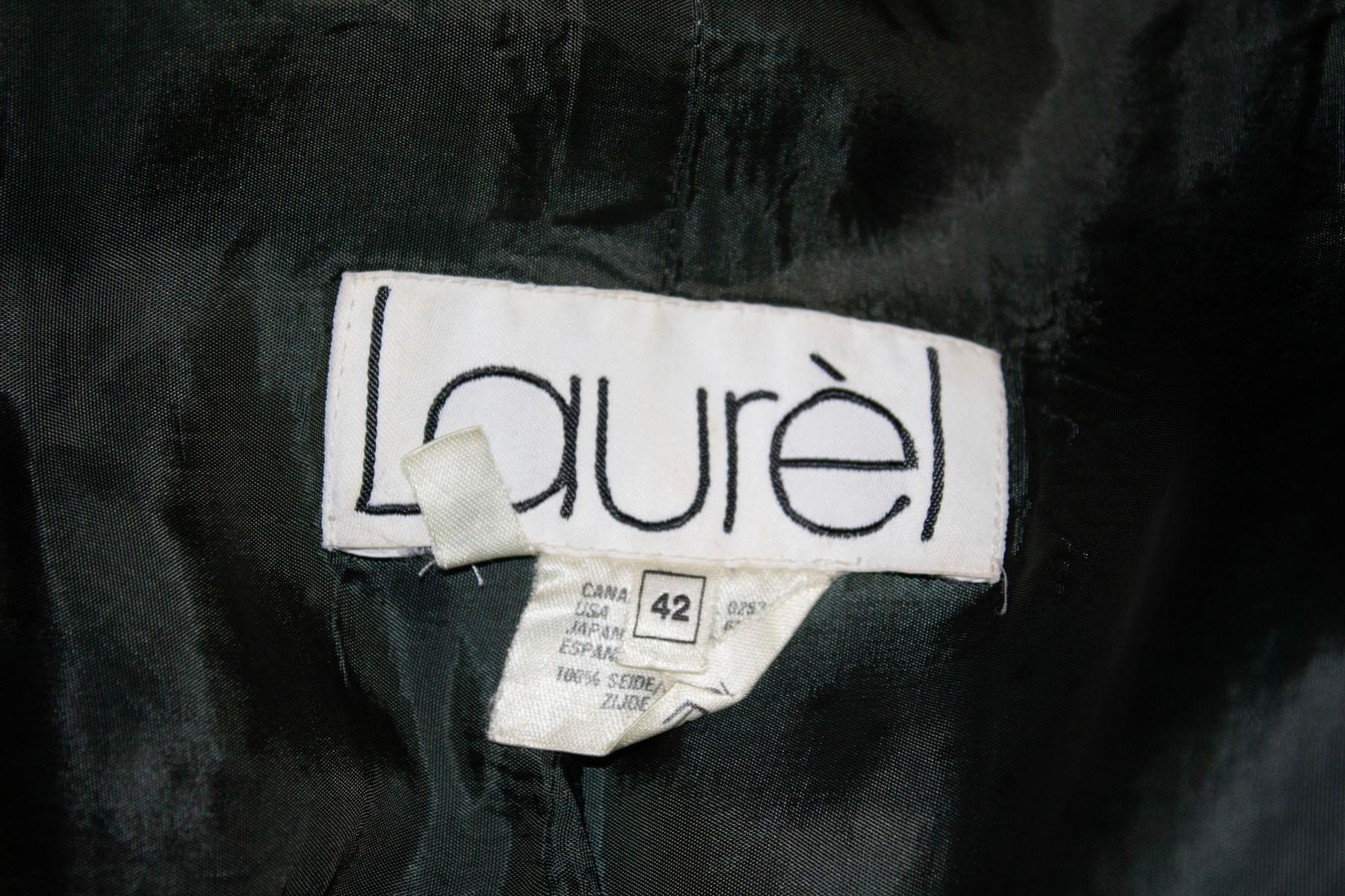 A wonderful  indulgent vintage silk jacket by Laurel. 
In a pretty grey/green colour, the jacket has a front zip front opening, with two large patch pockets. It has an elasticated waist, single button cuffs and is lined in silk. 
Measurements: Bust