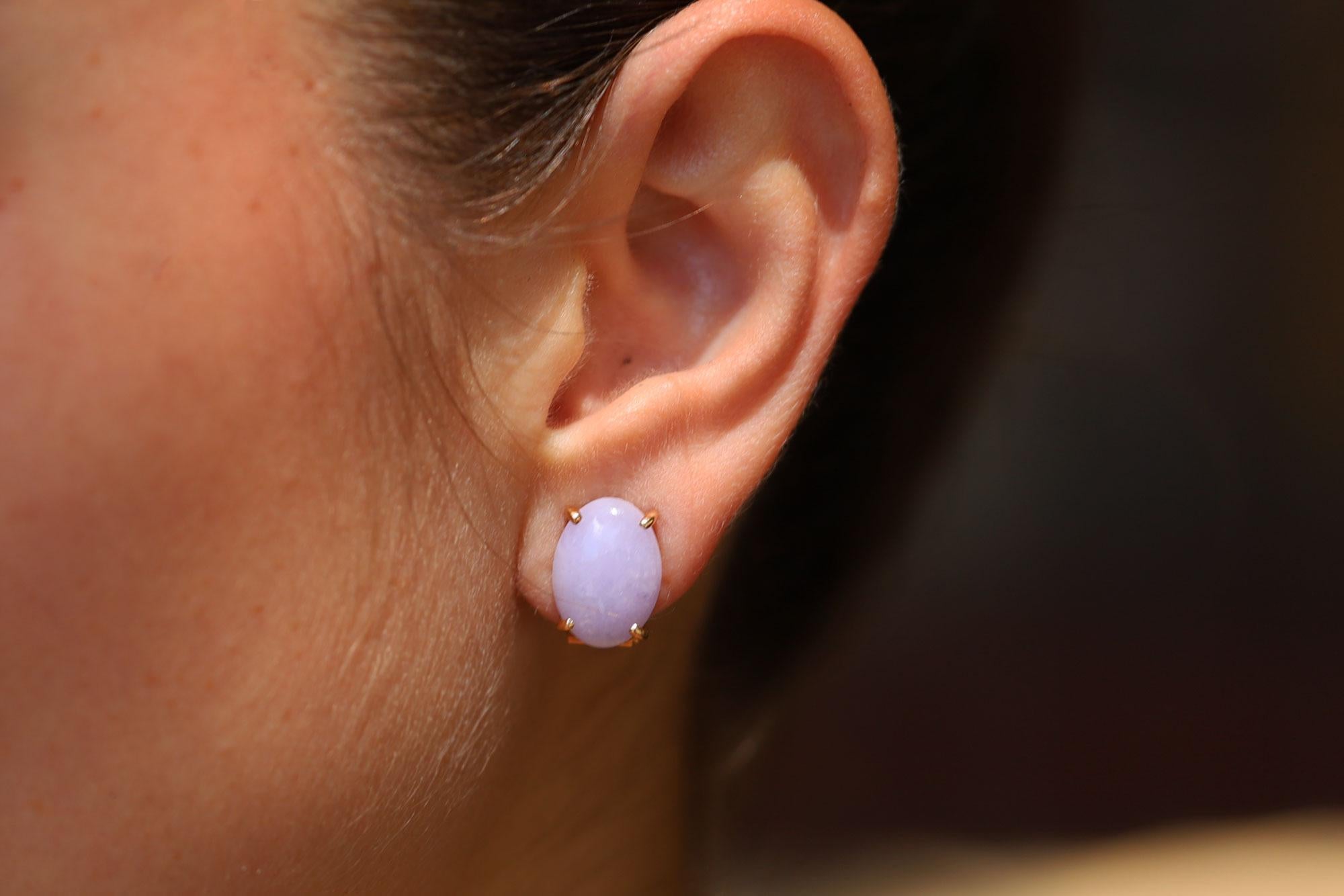 With a pleasing lavender color, these type A untreated natural jadeite jade earrings are a sure fire gift for her. The pure, polished cabochons feature a lovely luster and clear complexion, all mounted in the original 14k yellow gold lever back