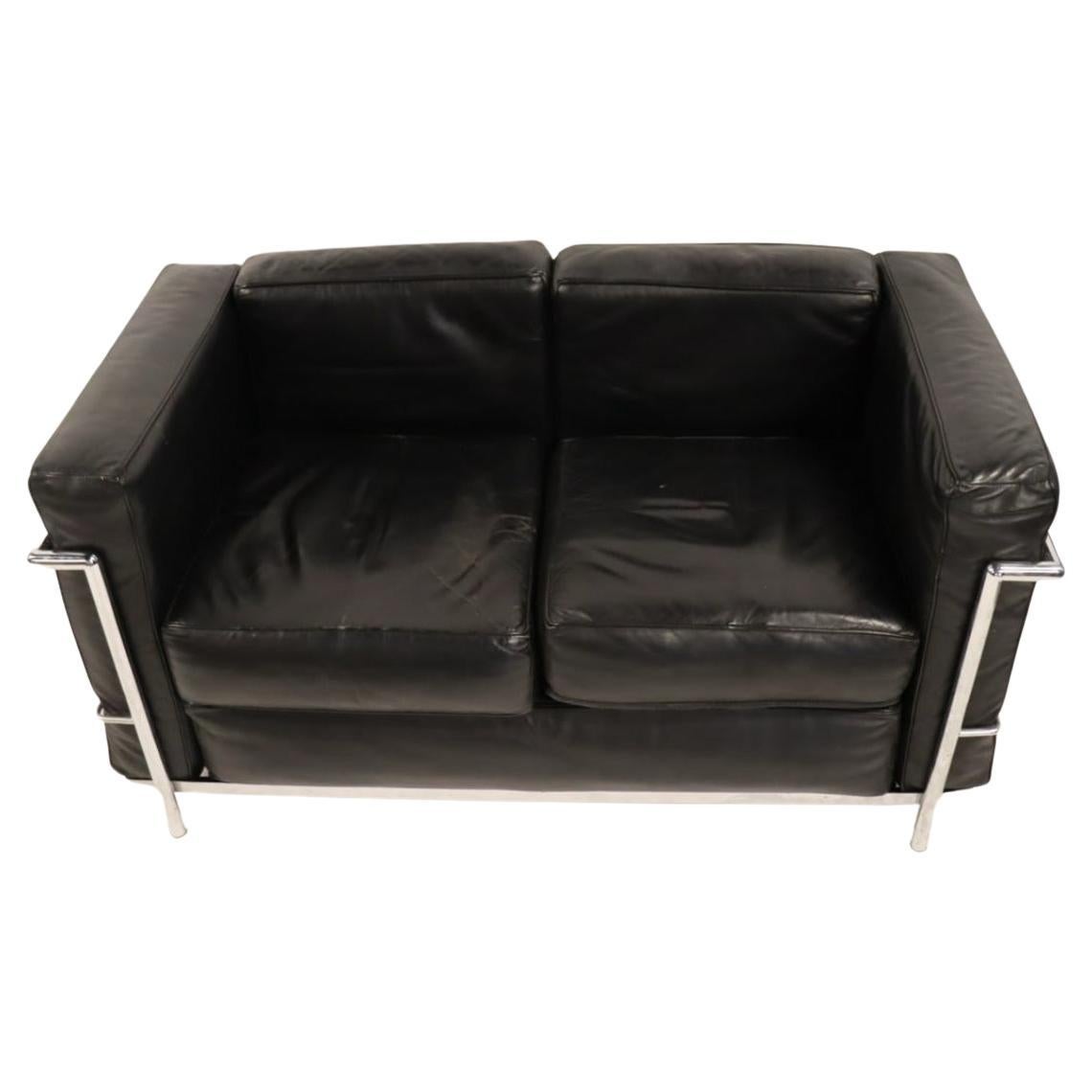 Vintage 2 seat sofa or lovseat by Le Corbusier. Model LC2 in black Leather in very good vintage condition shows use and patina. Triple chrome plated steel frame. All straps are good - all cushions come out. Made In Italy. No other Labels or stamps.