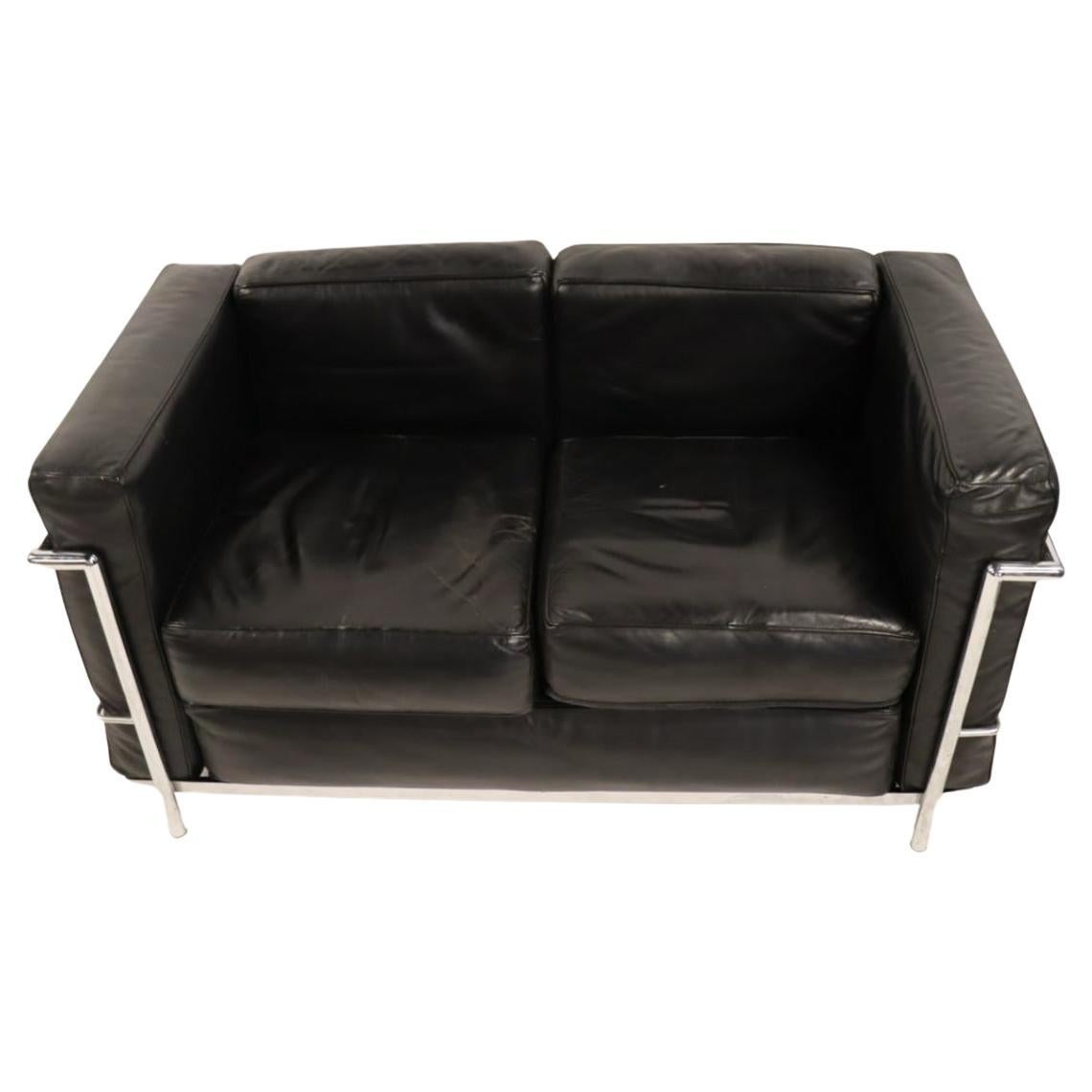 Vintage 2 seat sofa or lovseat by Le Corbusier. Model LC2 in black Leather in very good vintage condition shows use and patina. Triple chrome plated steel frame. All rubber straps are good - all cushions come out. Made In Italy. No other Labels or