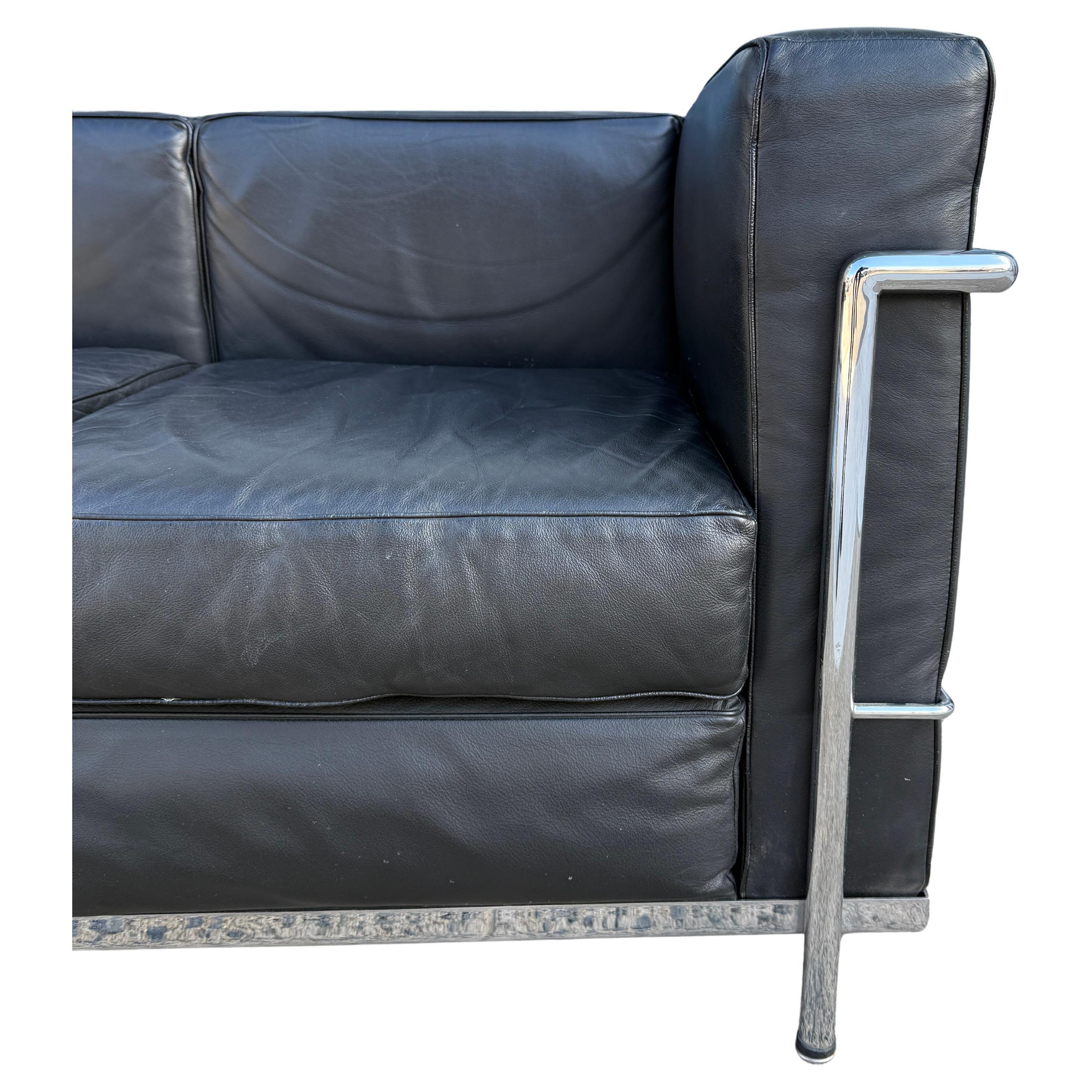 Vintage 2 seat sofa by Le Corbusier. Model LC2 in black Leather in very good vintage condition shows very little use. Triple chrome plated steel frame. All lower straps are good and all cushions are clean and removable. Made In Italy. No other