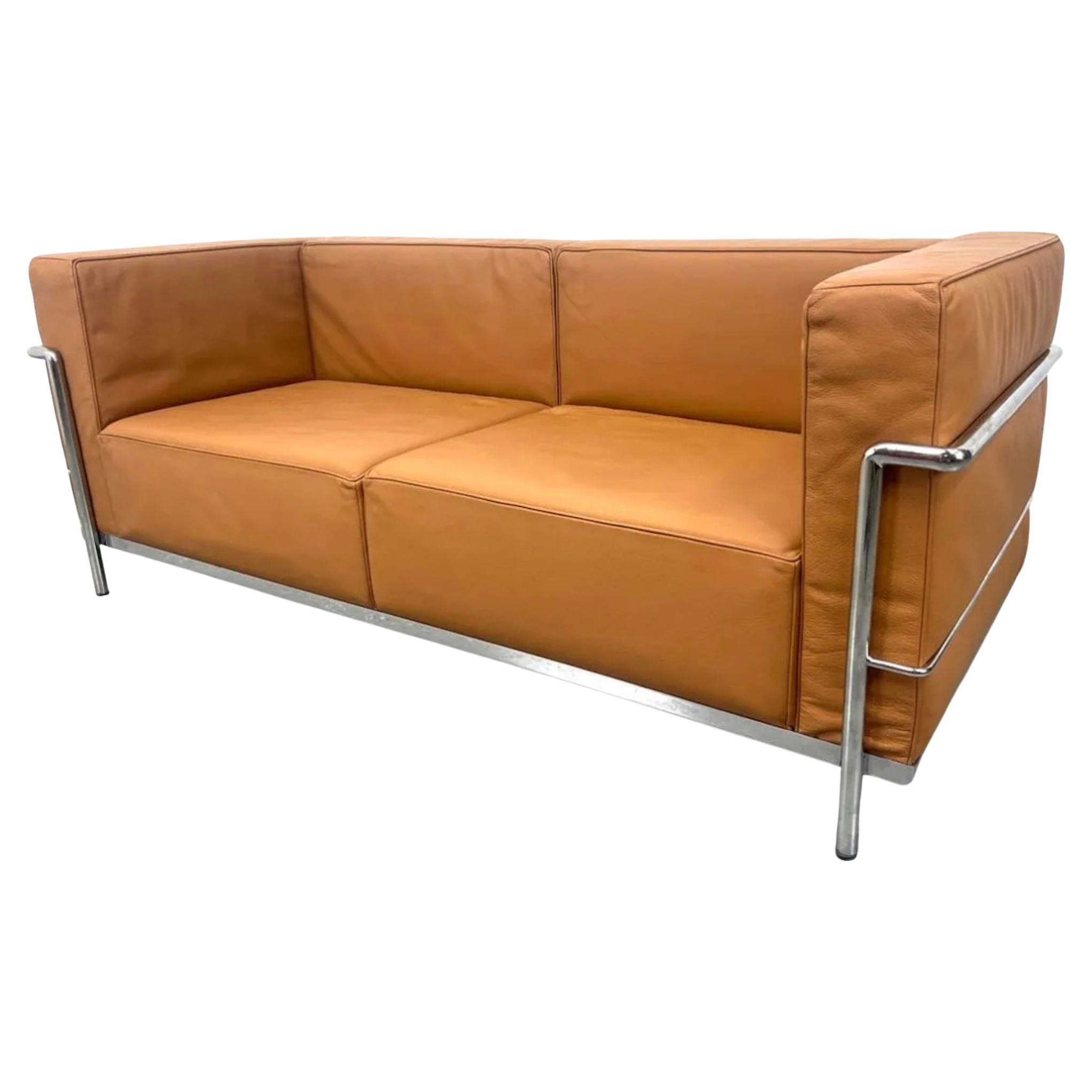 Vintage 2 seat sofa or lovseat by Le Corbusier. Model LC2 in Tan Leather in very good vintage condition. Triple chrome plated steel frame. Manufactured by Gordon International. All straps are good all cushions come out. Located in Brooklyn