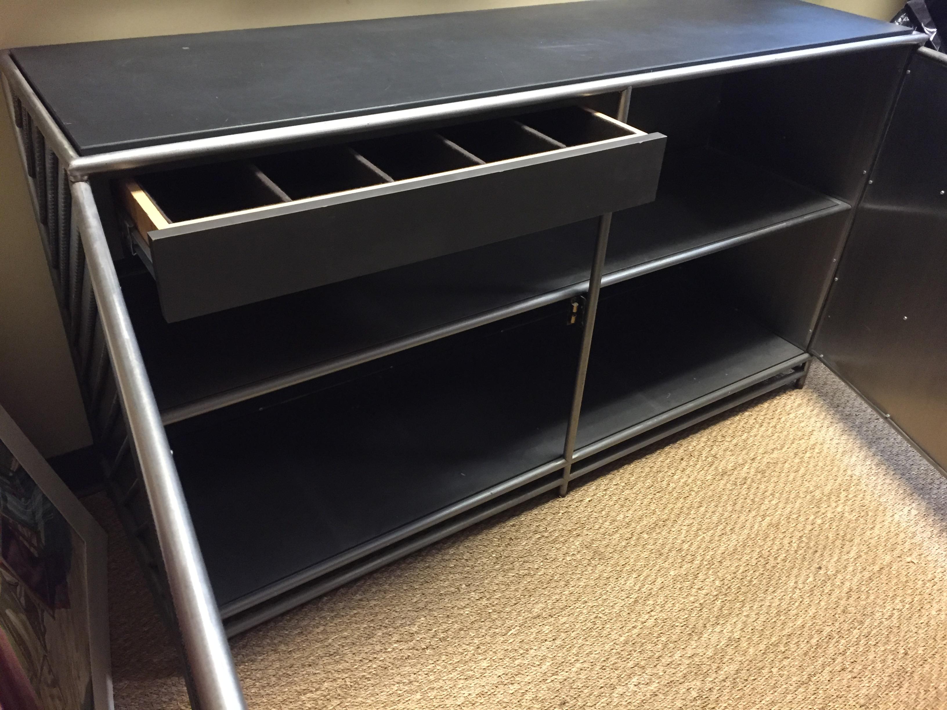 The LCS closed console is made of rust polished rebar and backed with antiqued stainless panels.
Interior is finished with mica shelf and one divided drawer lined for silver
Top is of honed inset slate.
Great piece for both residential and