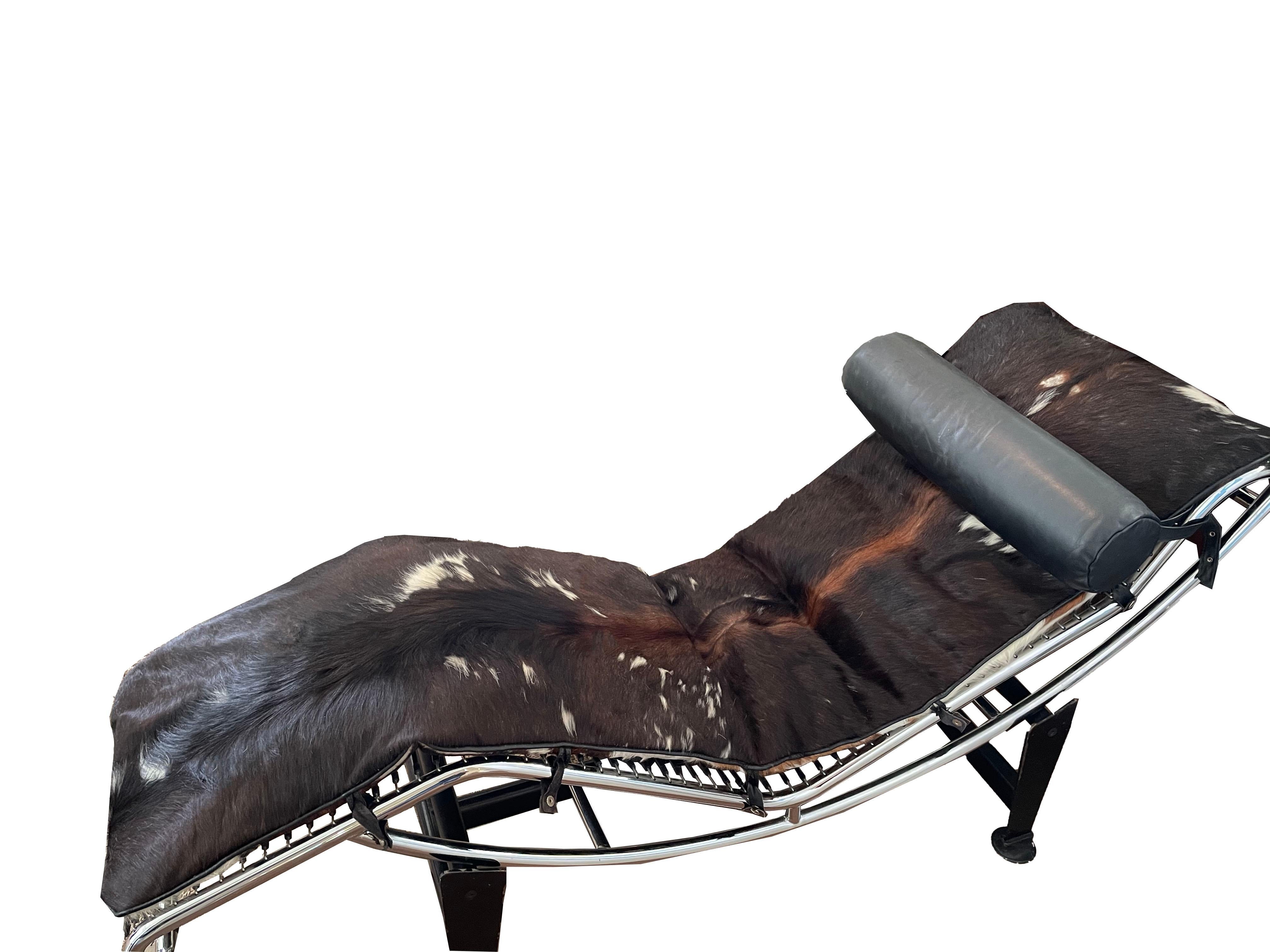 Vintage LC4 Italian chaise lounge in the manner of Le Corbusier. The chrome frame rolls over a black metal base. This piece is not marked but is an old version, late 1960's.
The top hide has been replaced, but all of the under hide, and leather