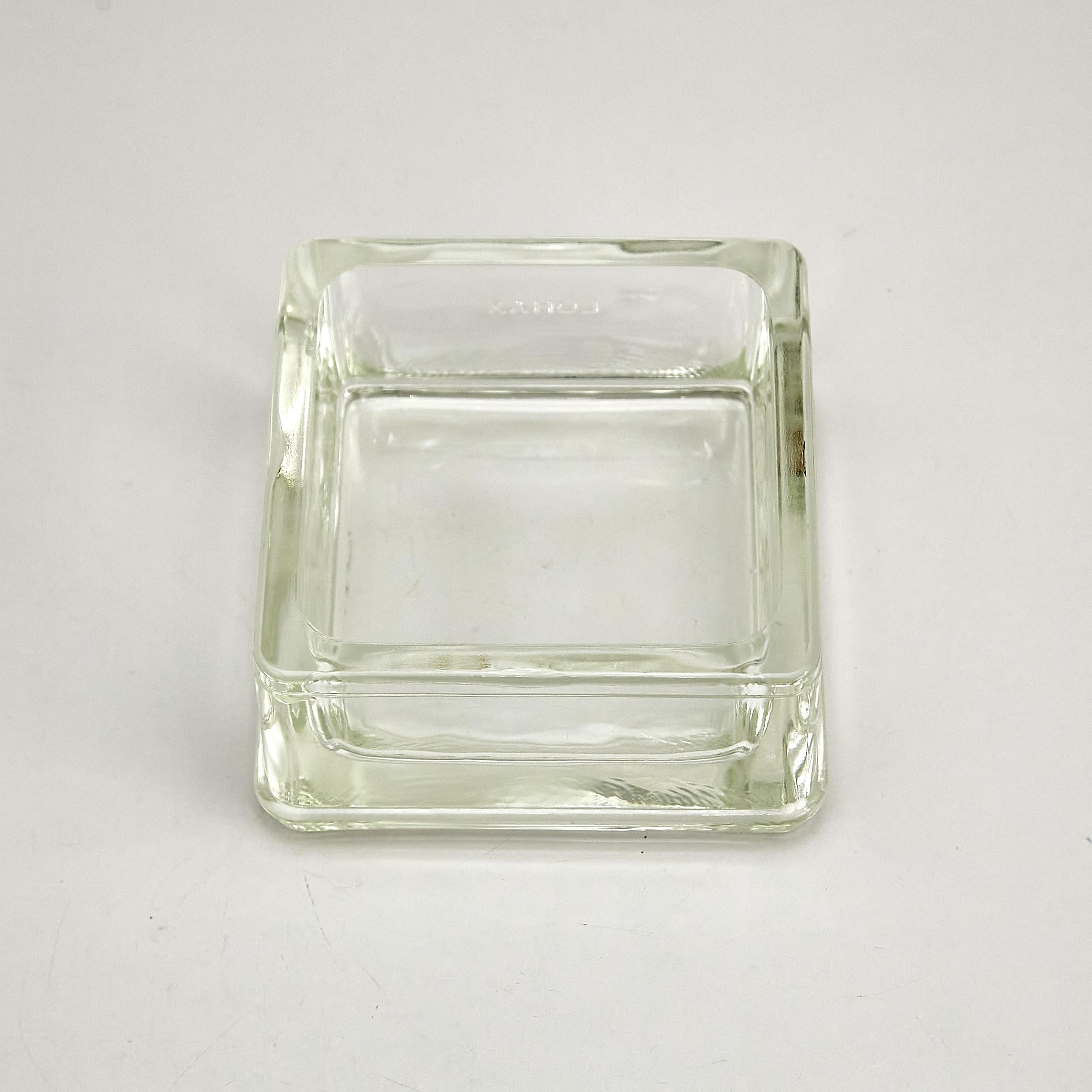 Introducing the remarkable Lumax Ashtray, a vintage masterpiece designed by the legendary Le Corbusier and Charlotte Perriand, circa 1970. Manufactured in France, this exquisite glass ashtray embodies the essence of modernist design, featuring clean