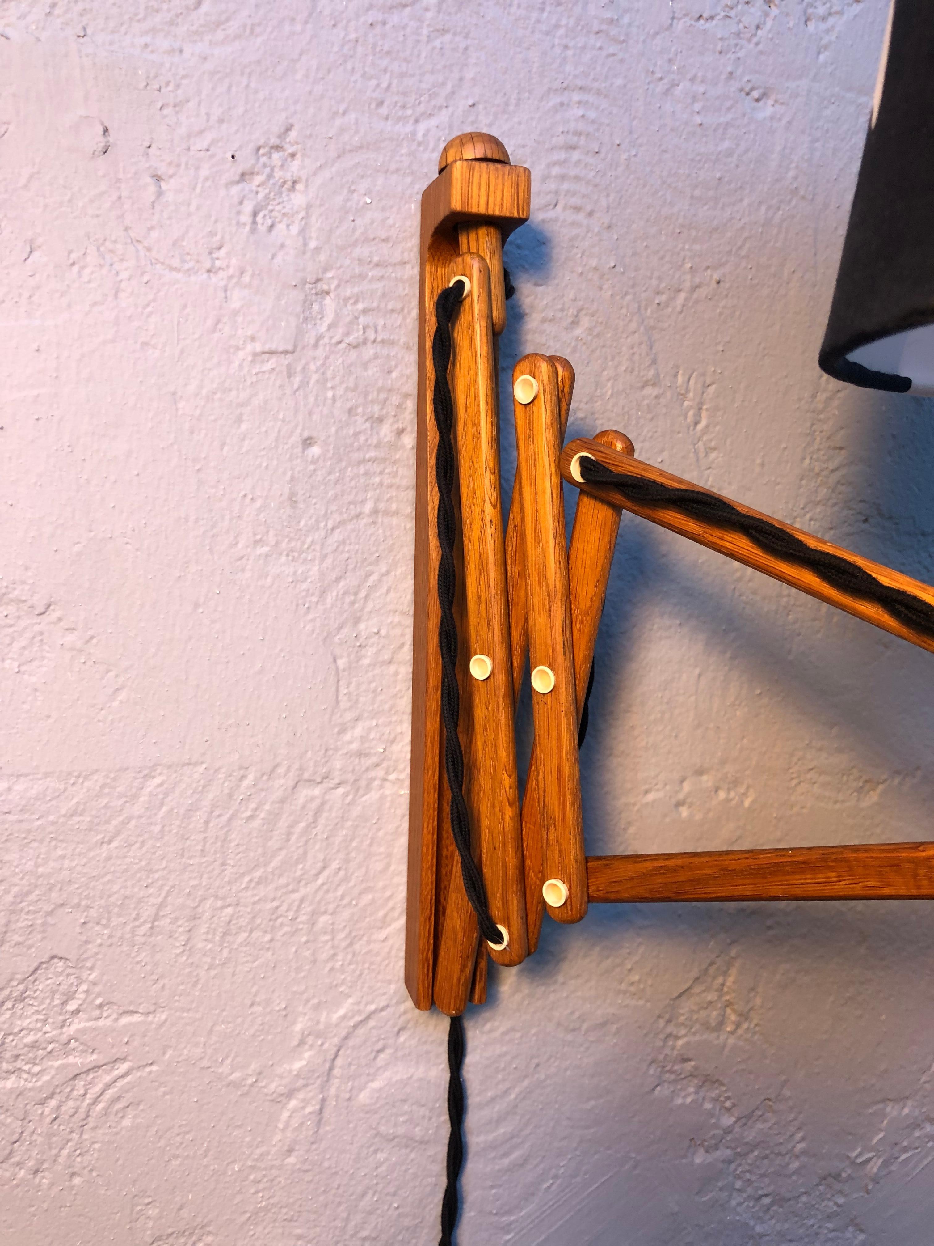 Iconic vintage Le Klint scissor lamp up light in oak from the late 1960s.
The oak has been lightly sanded and waxed without removing the beautiful dark patina to the wood. 
In great vintage condition with new black cloth twisted flex wiring and