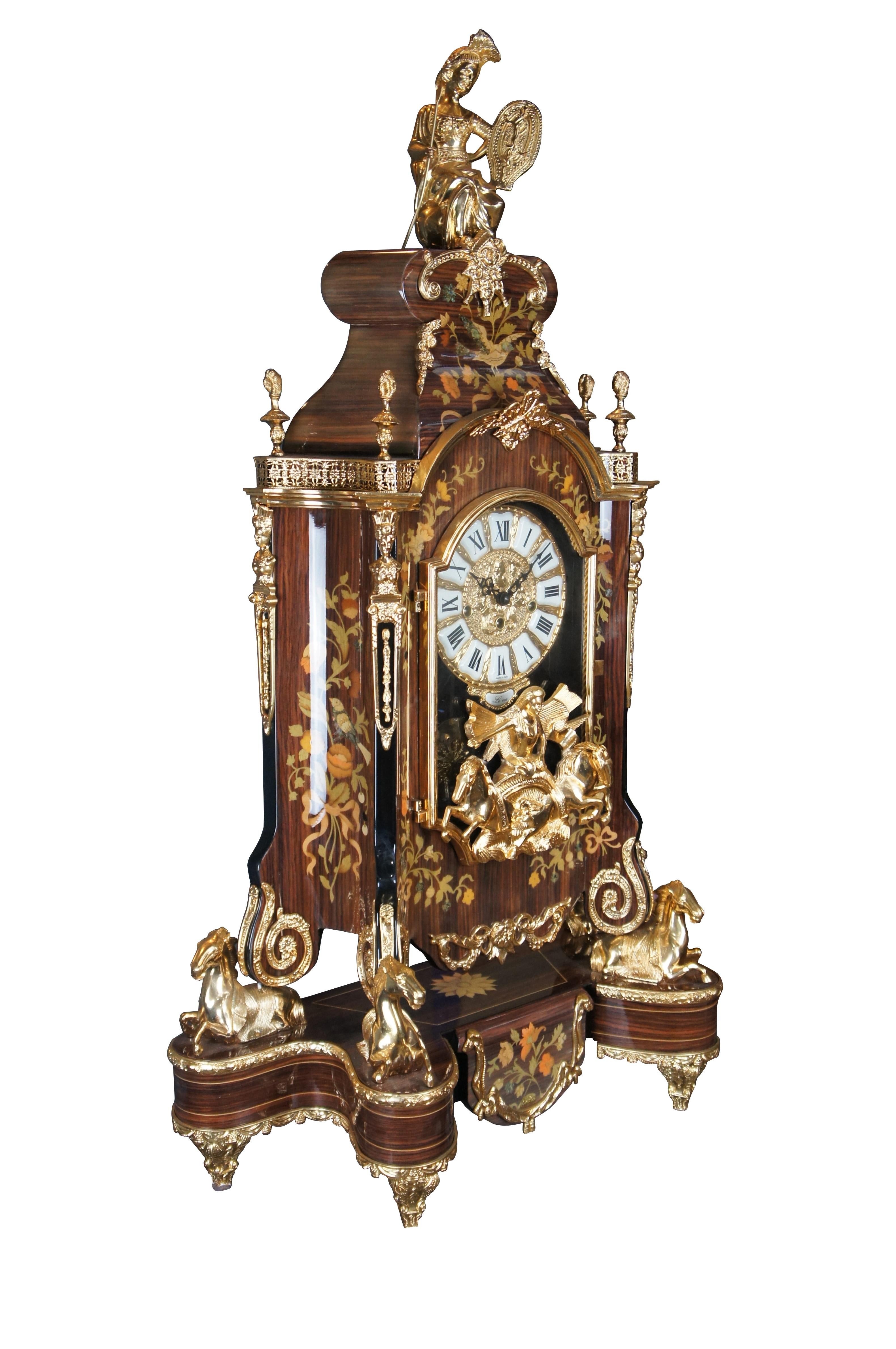 Stunning Italian Boulle style mantel clock by Le Ore New Art International. Le Ore is a small Italian family manufacturer that specializes in intricate and colorful wood inlay. Features large mounted sculptures and heavy gold plated cast brass