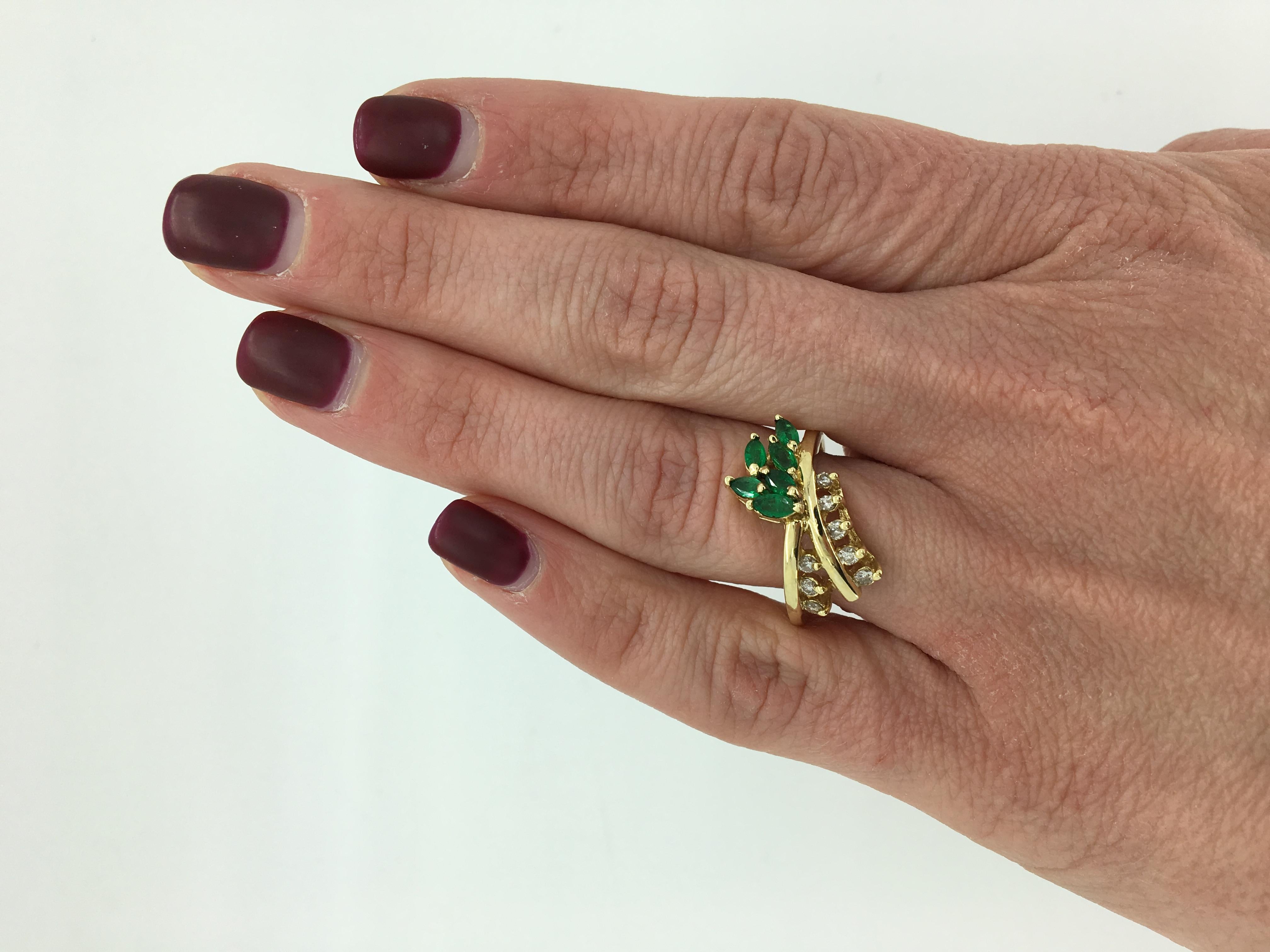 Vintage Le Vian emerald and diamond ring with a unique bypass design.

Gemstone: Emerald & Diamond
Gemstone Carat Weight: 6 Approximately 4.5 x 2mm Marquise Cut Emeralds 
Diamond Carat Weight: Approximately .20CTW
Diamond Cut: 8 Round